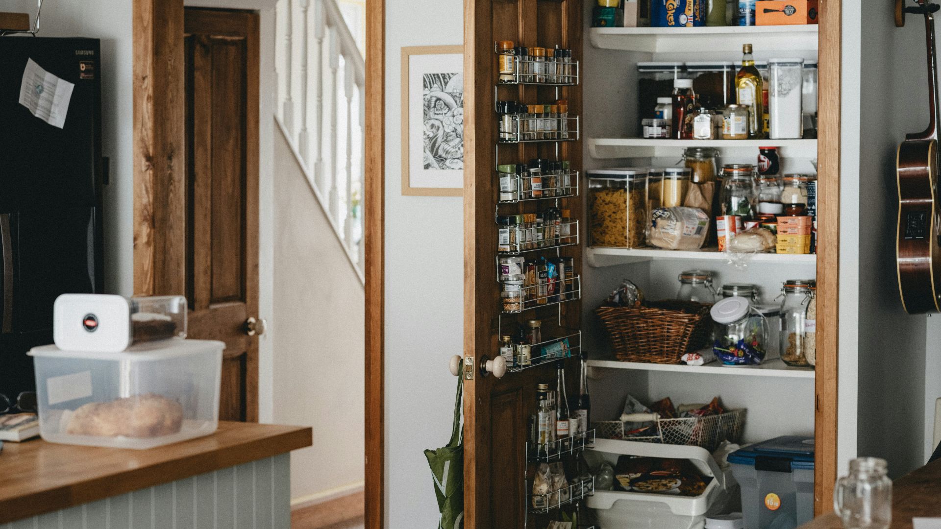 white plastic trash bin beside brown wooden shelf