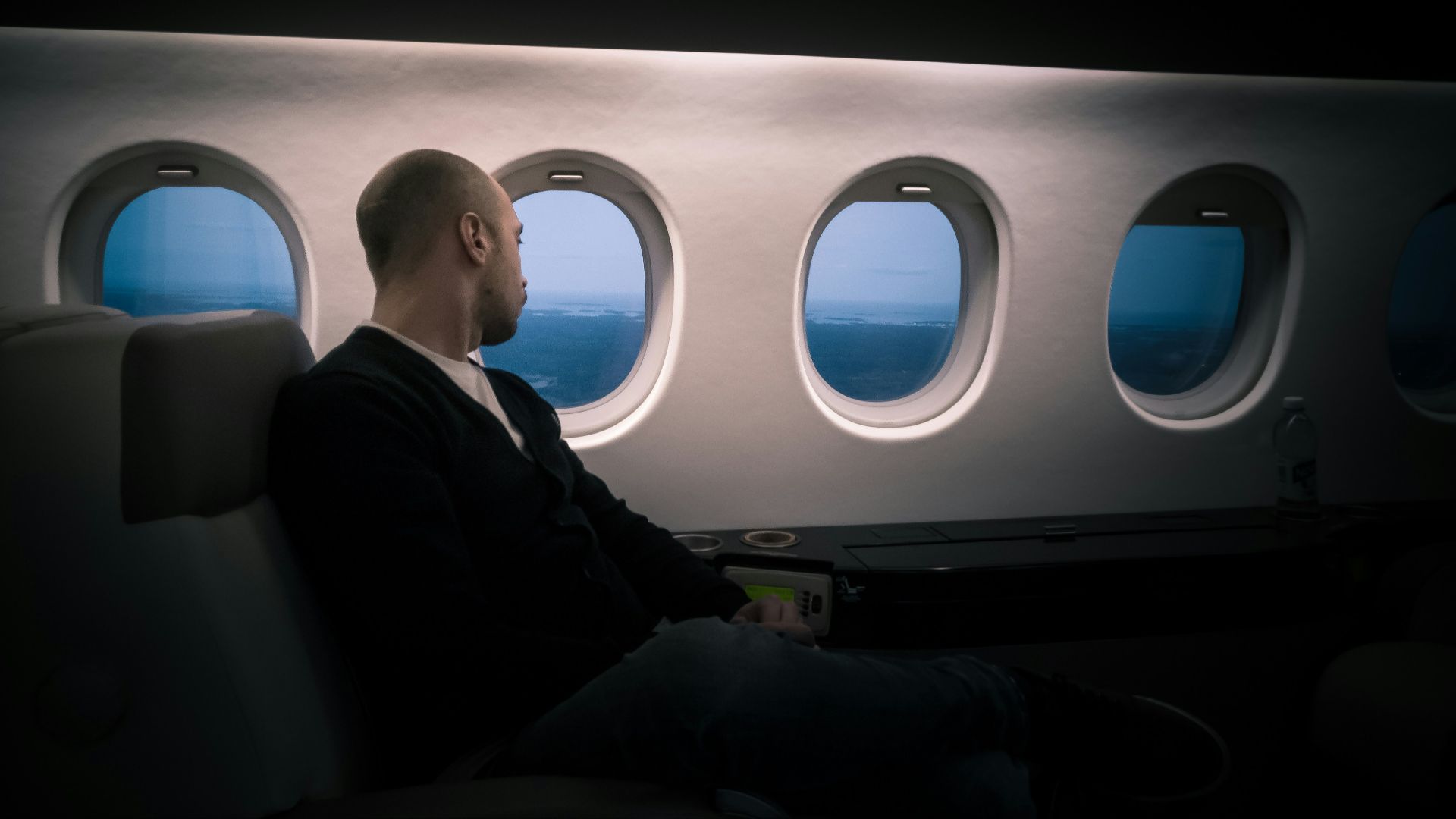 man seating near window
