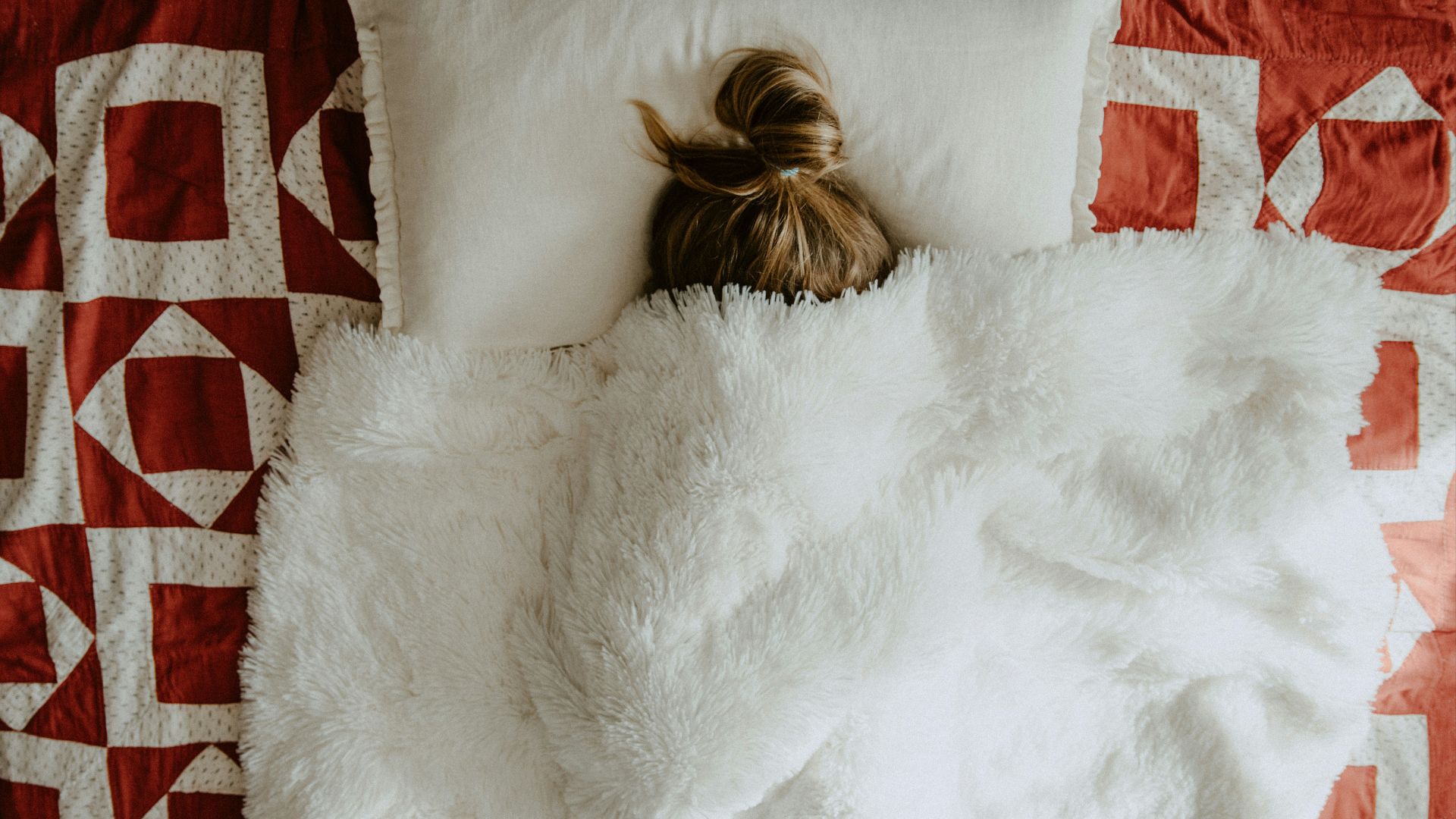 white fur textile on red and white textile