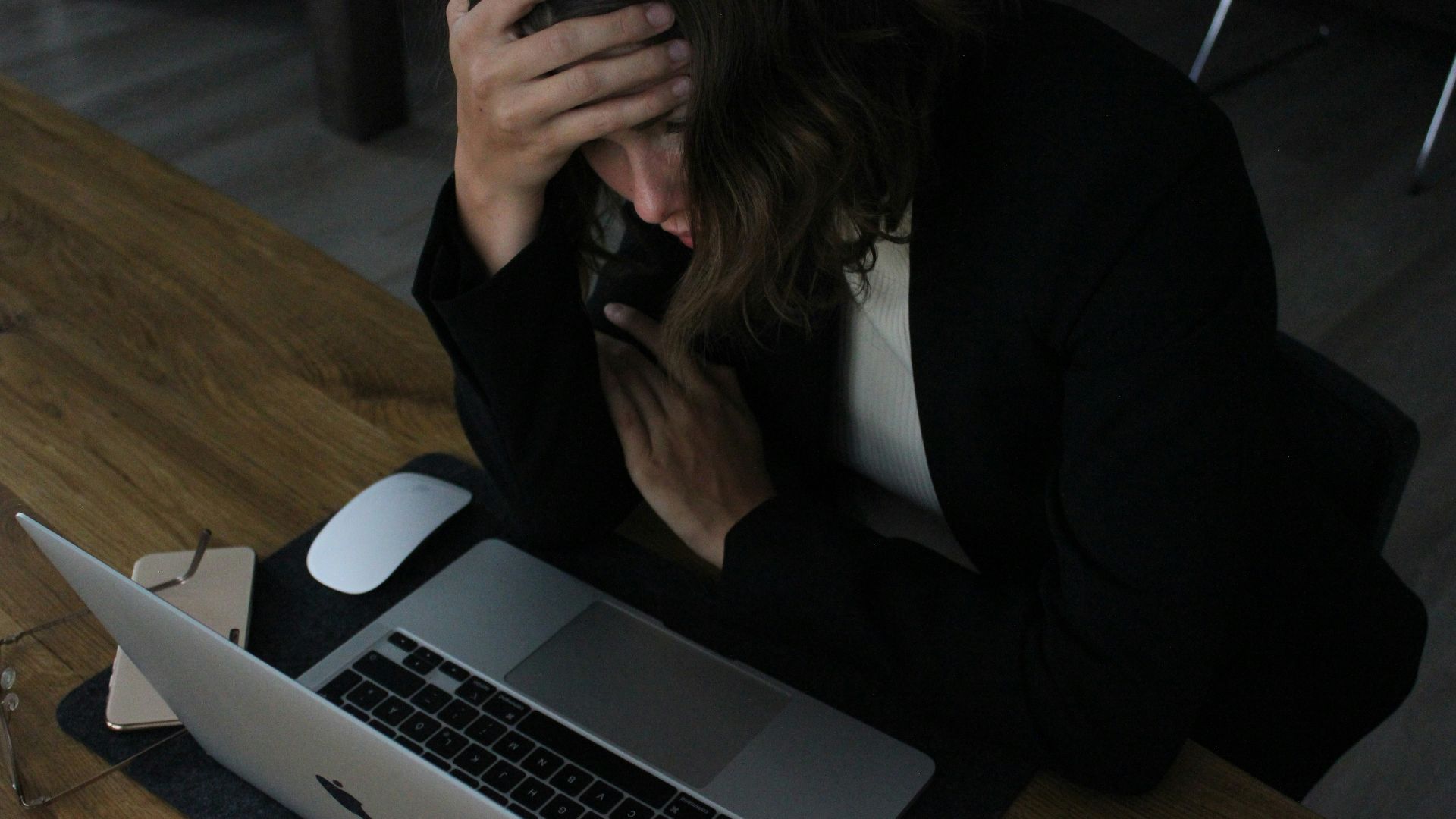 woman in black blazer sitting on chair