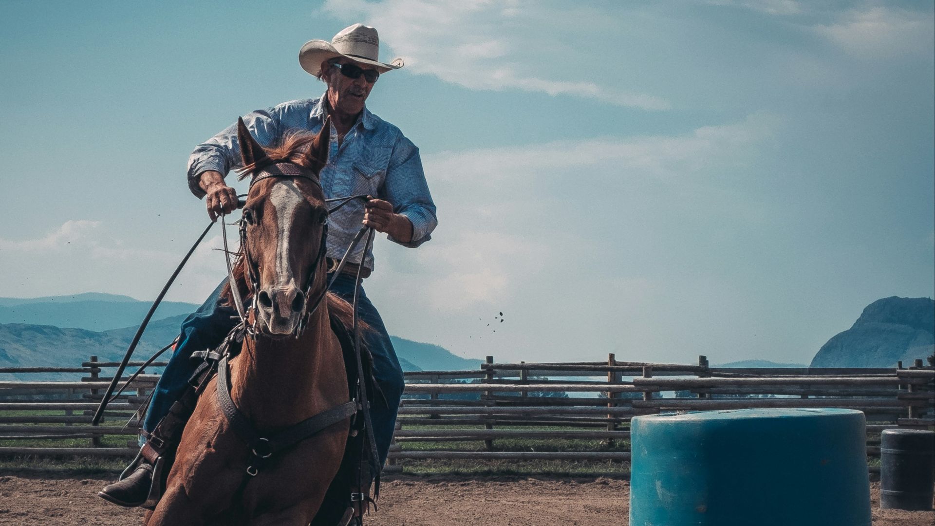 man in white cowboy hat riding a horse