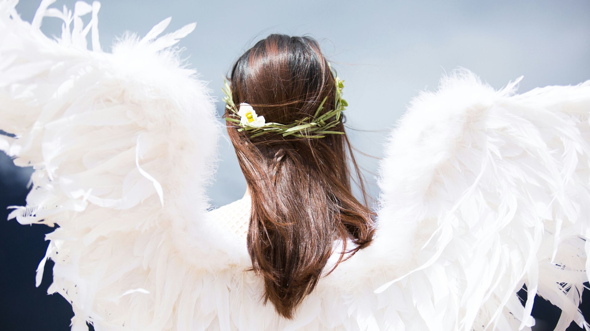 woman wearing white angel wings