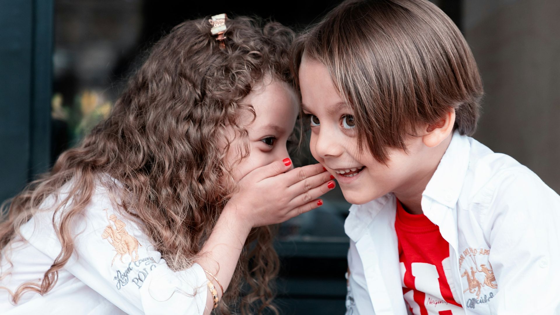 woman in white long sleeve shirt kissing girl in white long sleeve shirt
