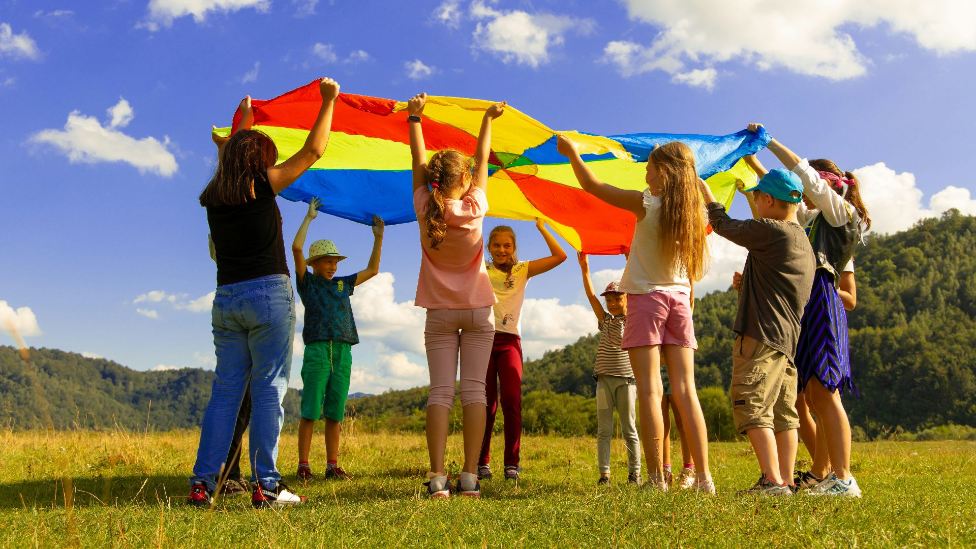 group of women standing on green grass field during daytime
