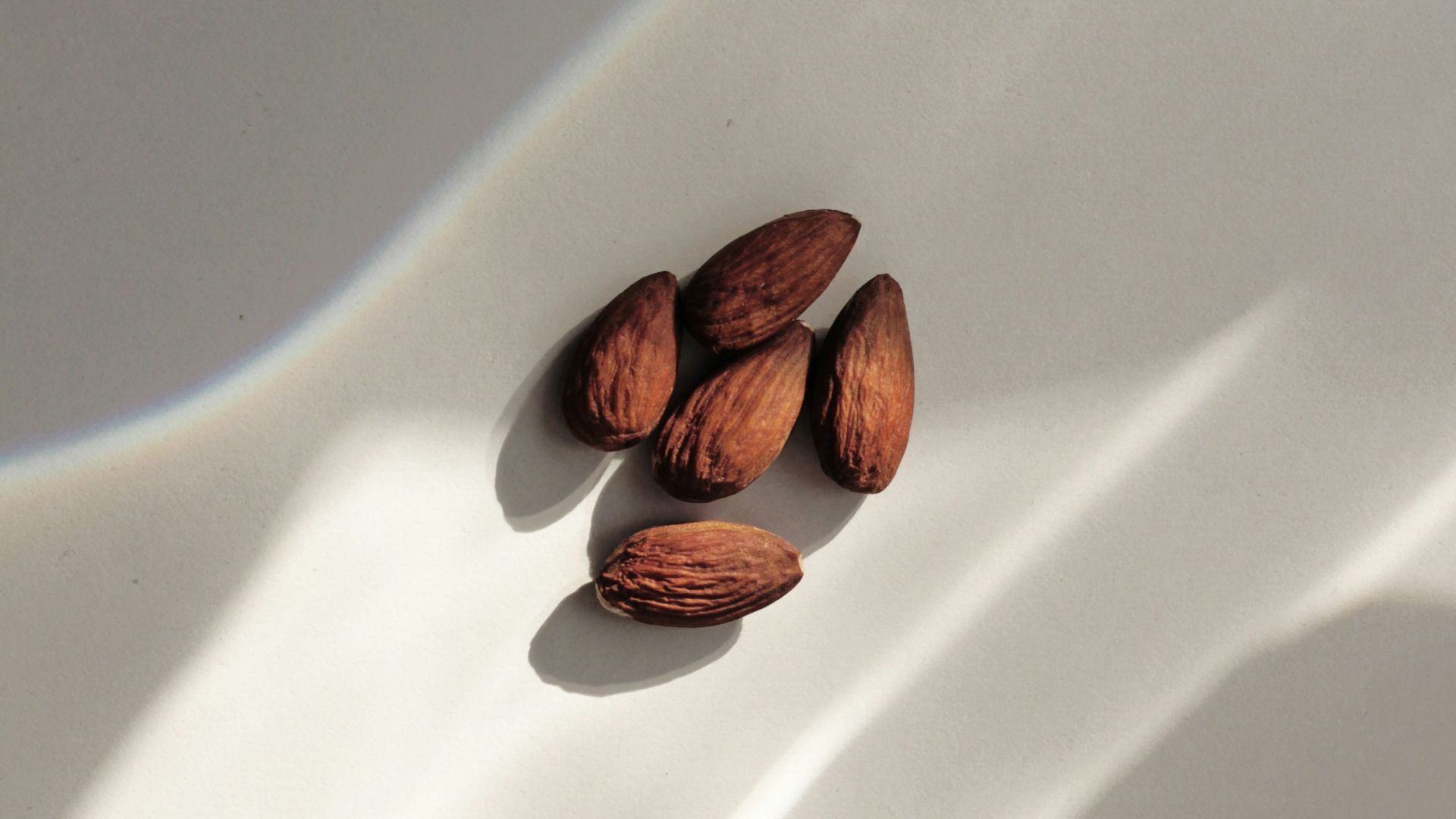 close-up of almond nuts on white surface