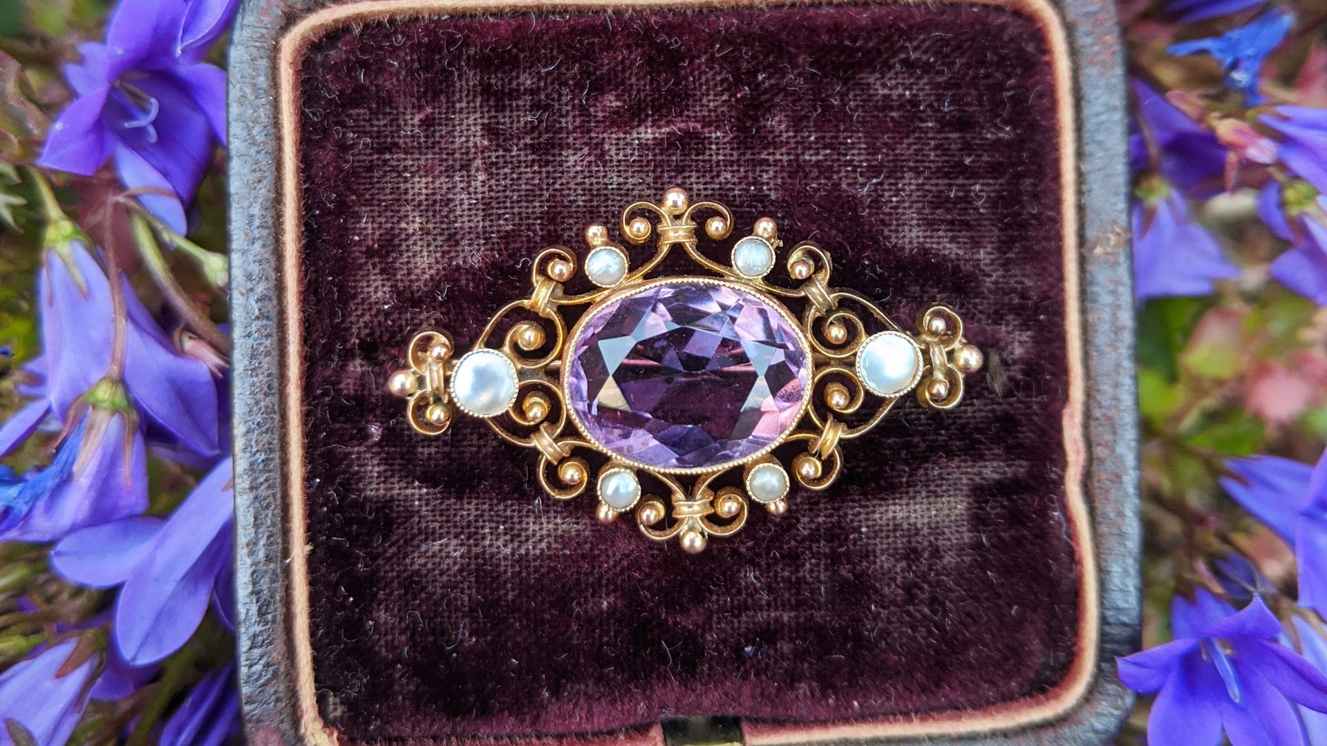 gold and silver round analog watch on black and purple case