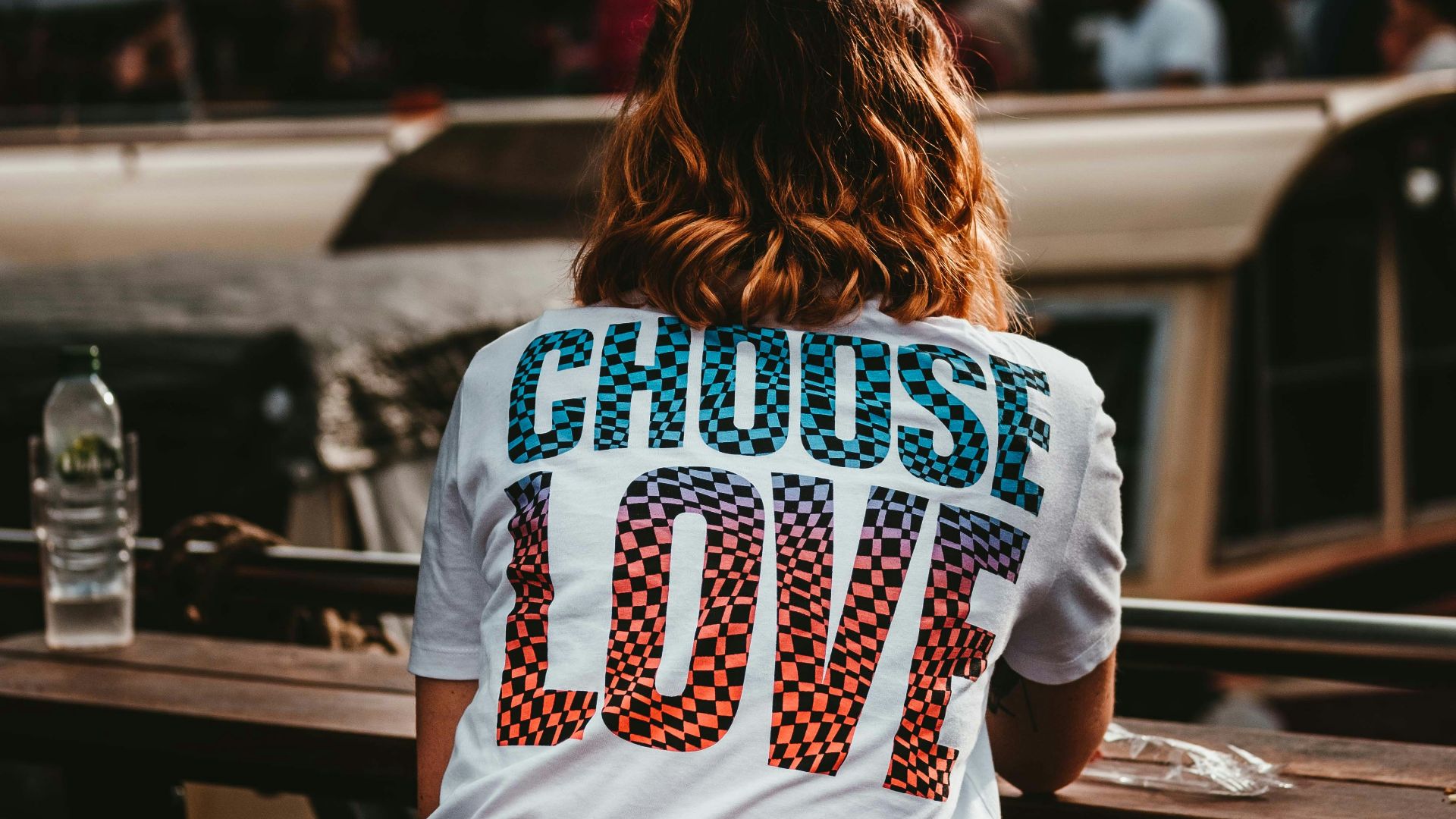 woman sitting on brown wooden bench