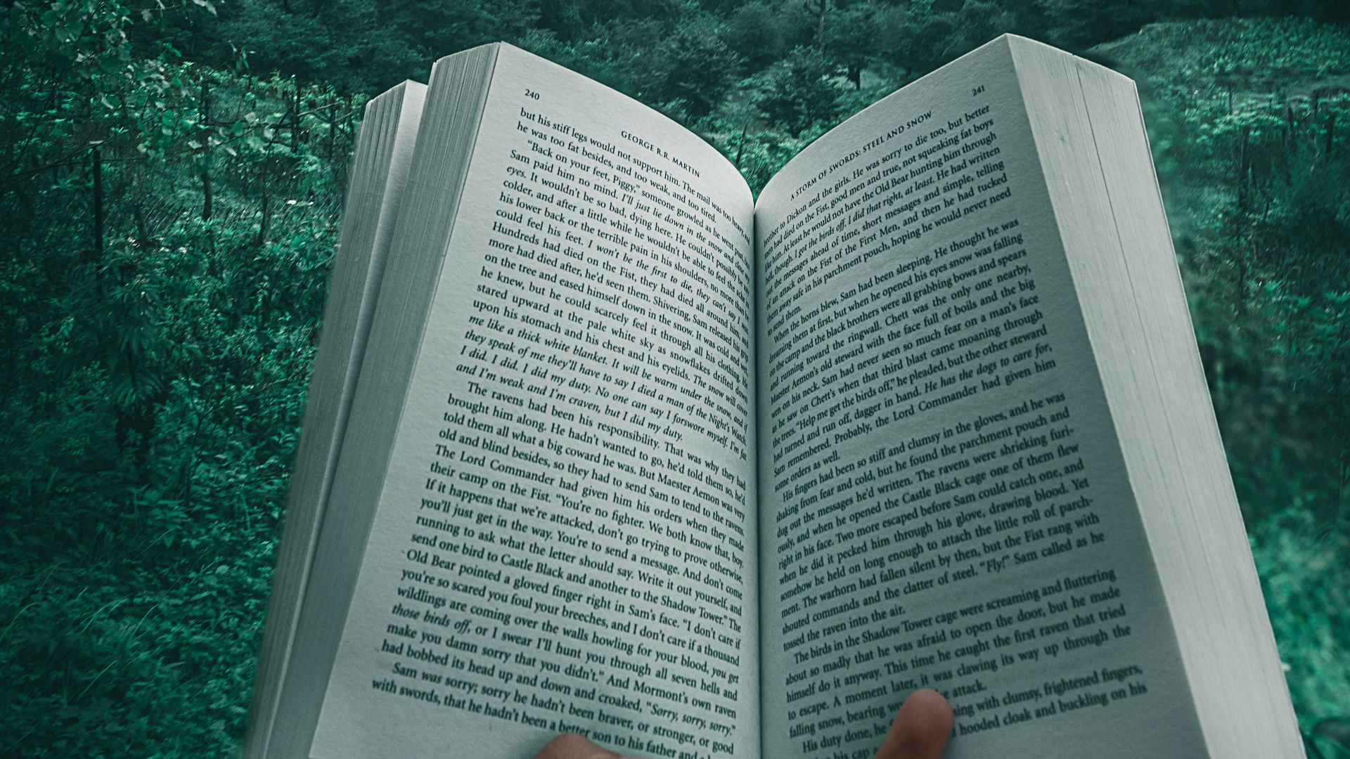 person holding open book viewing mountain view