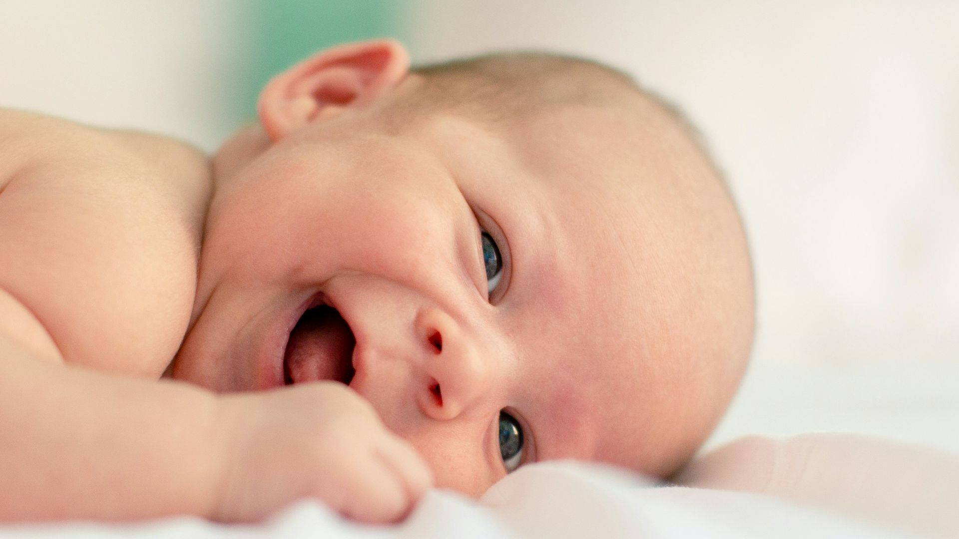 baby lying on fabric cloth