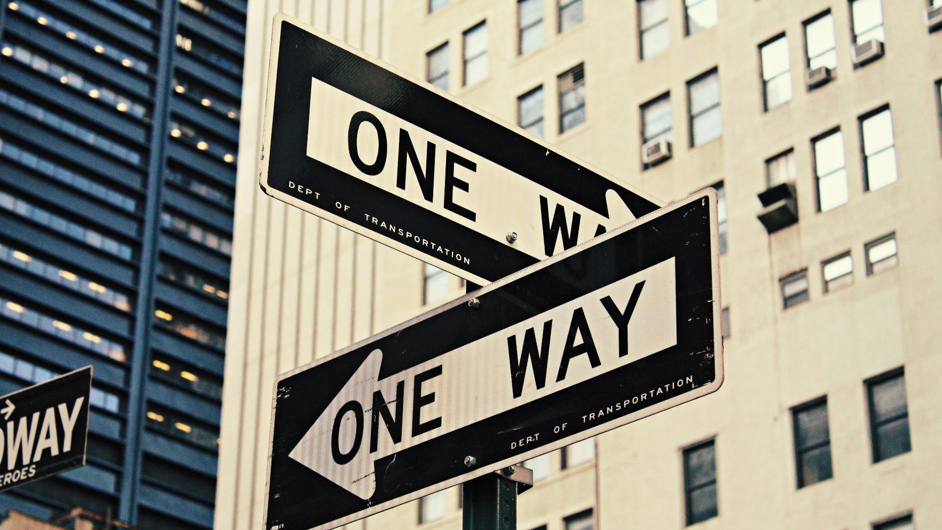 white and black One Way-printed road signages