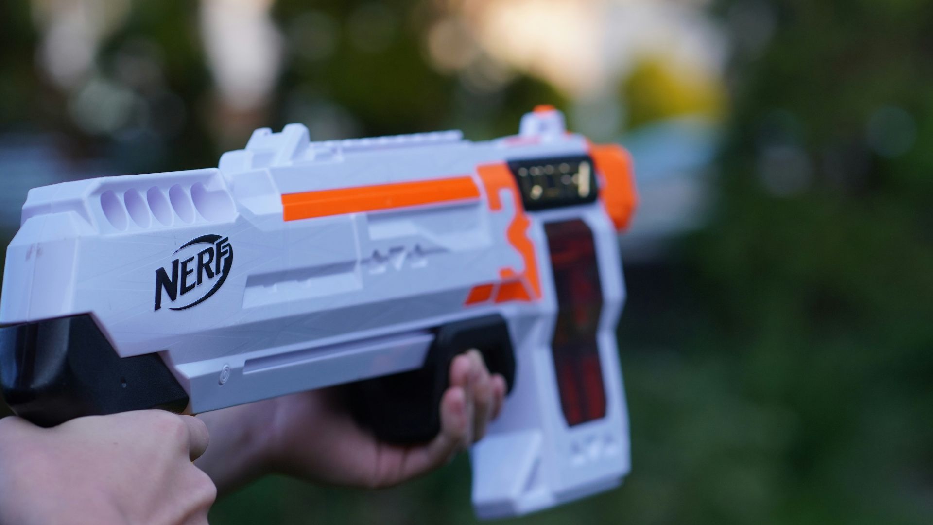 a young boy holding a nerf nerf nerf nerf nerf ne