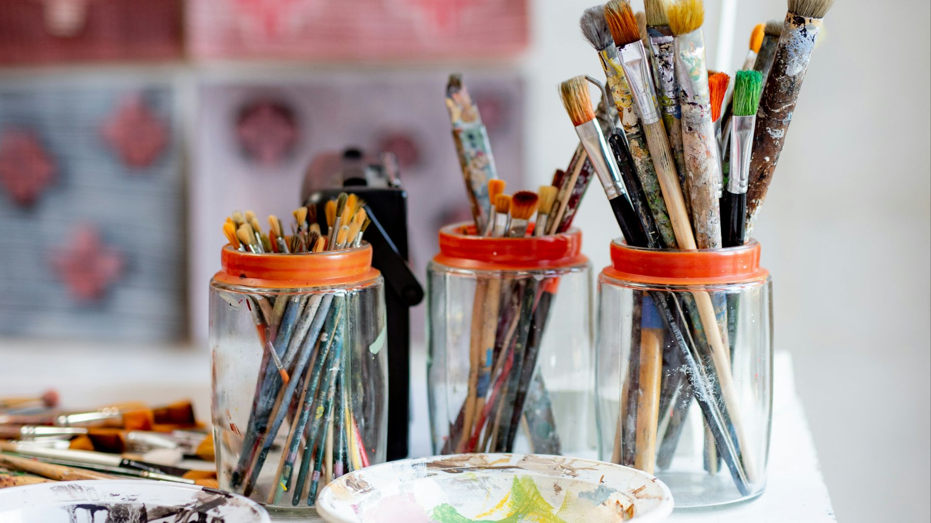 white ceramic plate with paint brushes and paint brushes