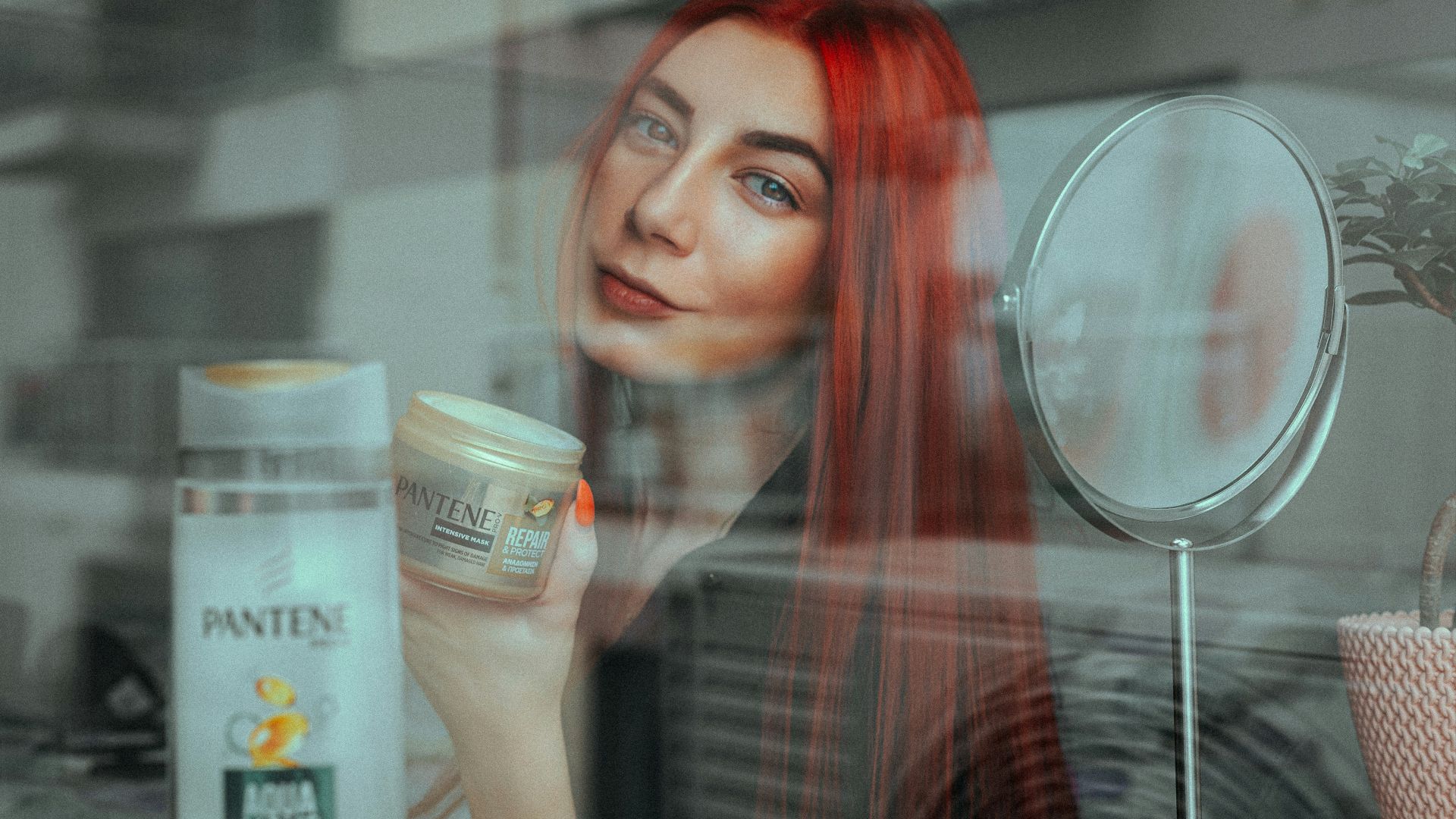 woman holding white and blue plastic cup