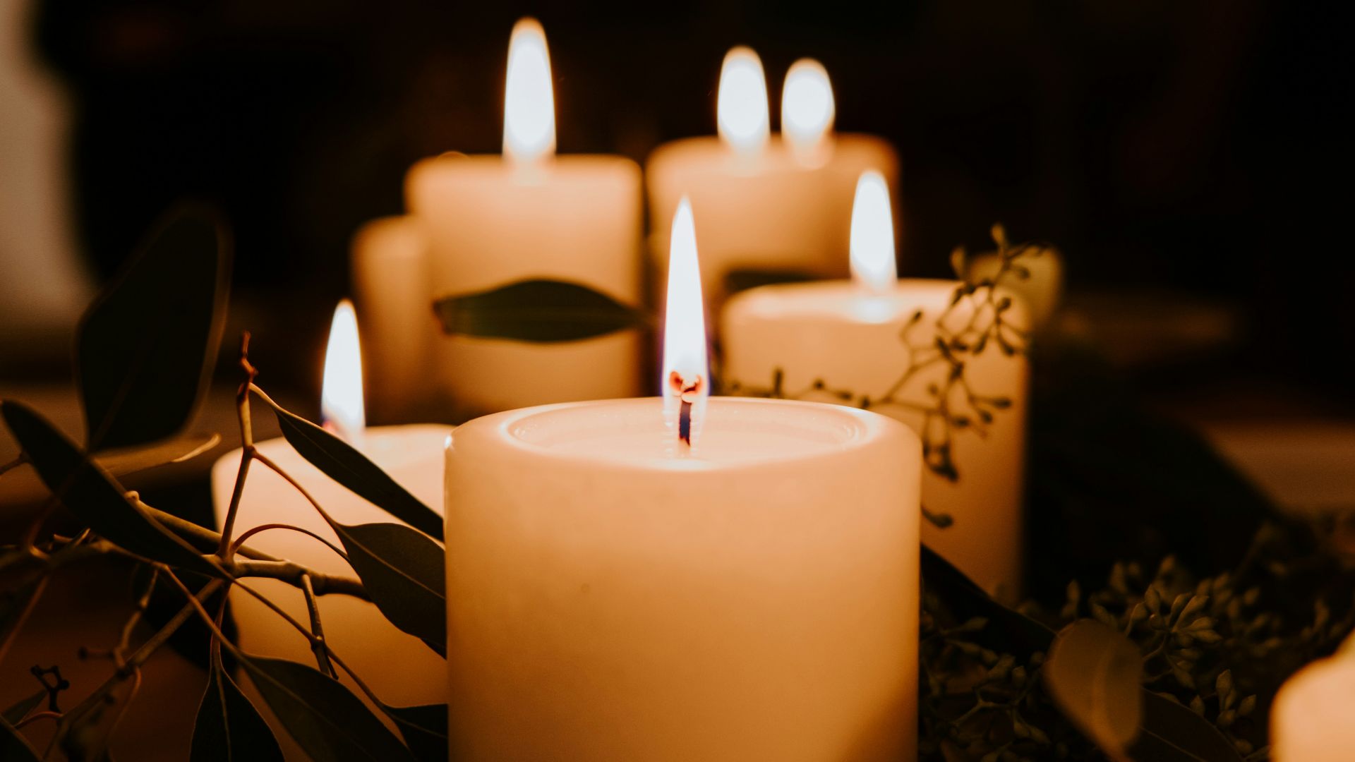 white pillar candles on black holder