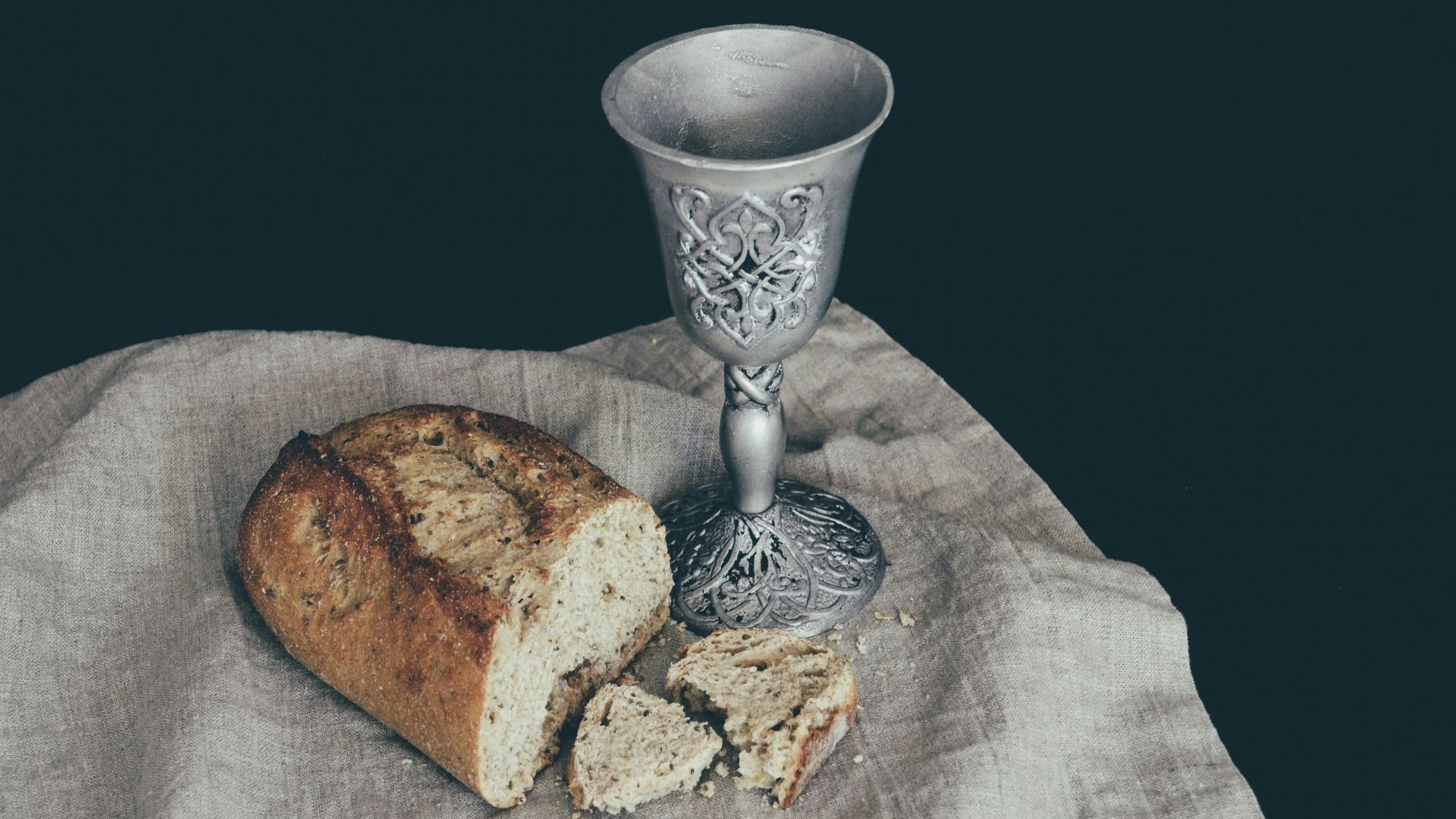 sliced of bread beside goblet