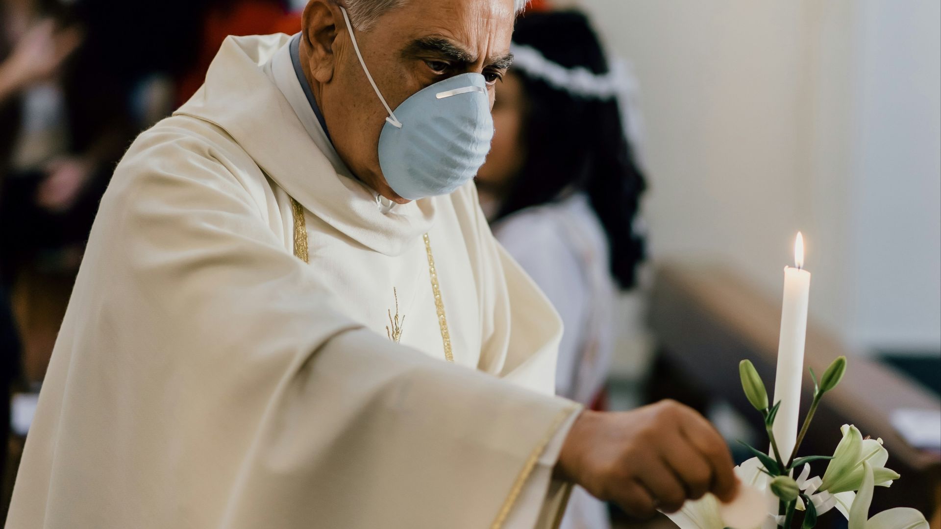 man in white dress shirt holding white flower