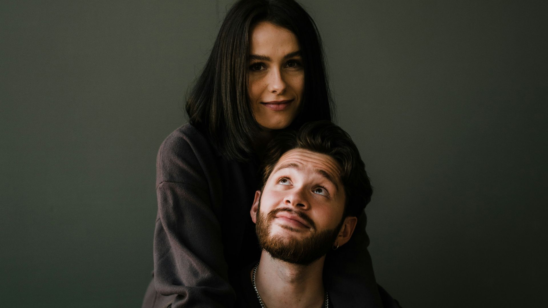 man in black crew neck shirt beside woman in black long sleeve shirt