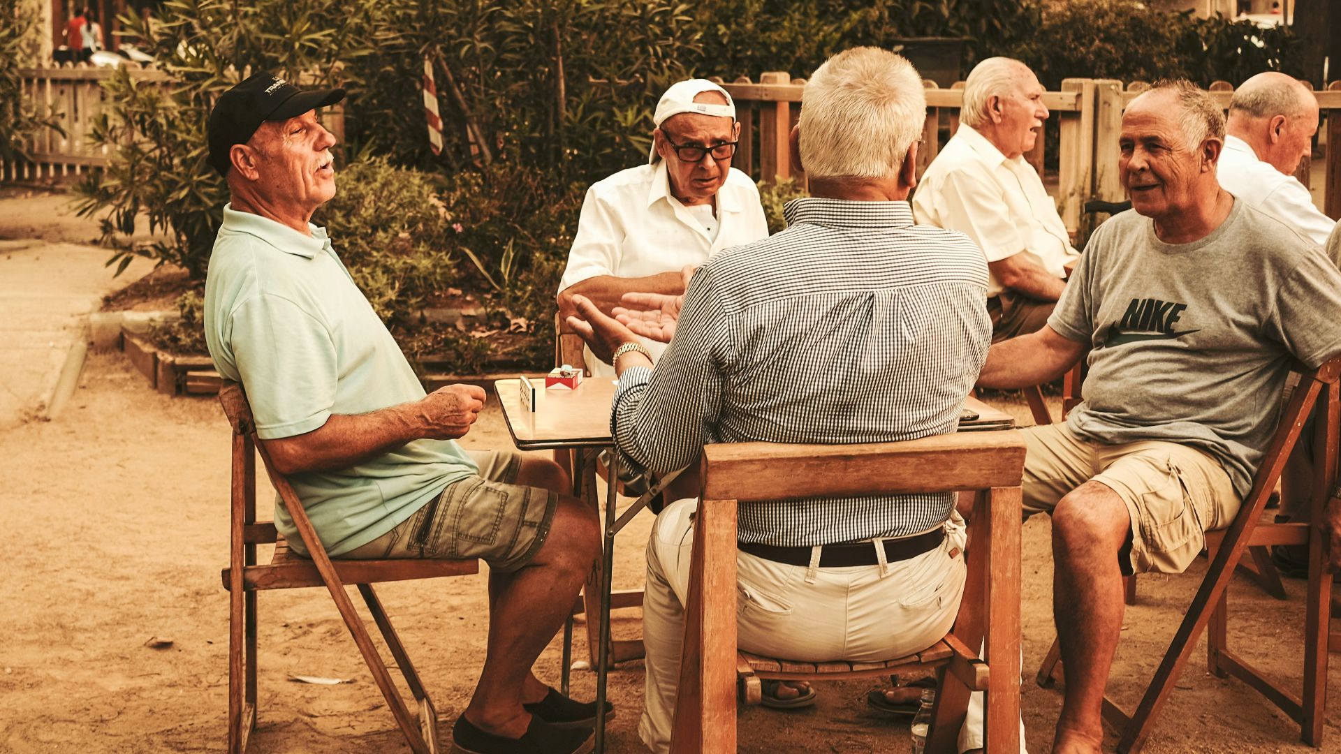 group of old men sitting near table