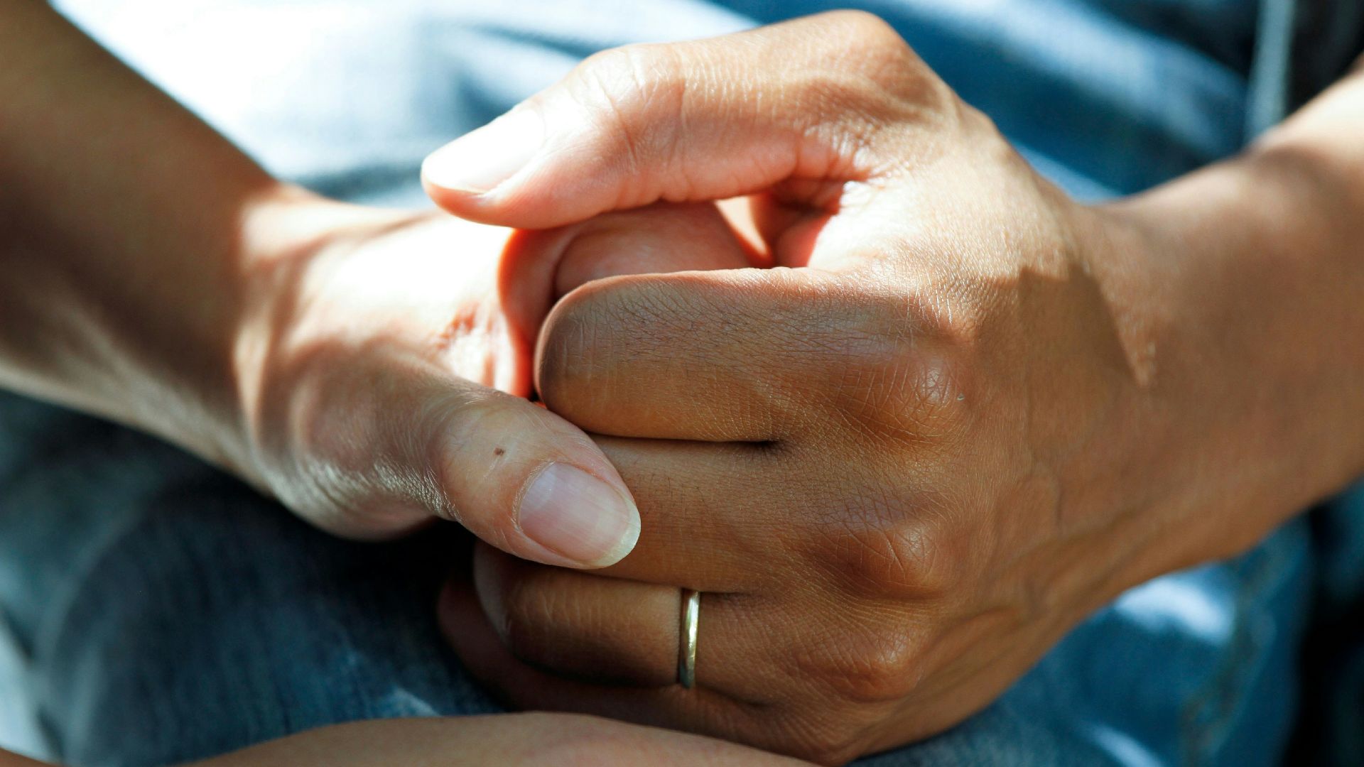 person wearing gold wedding band