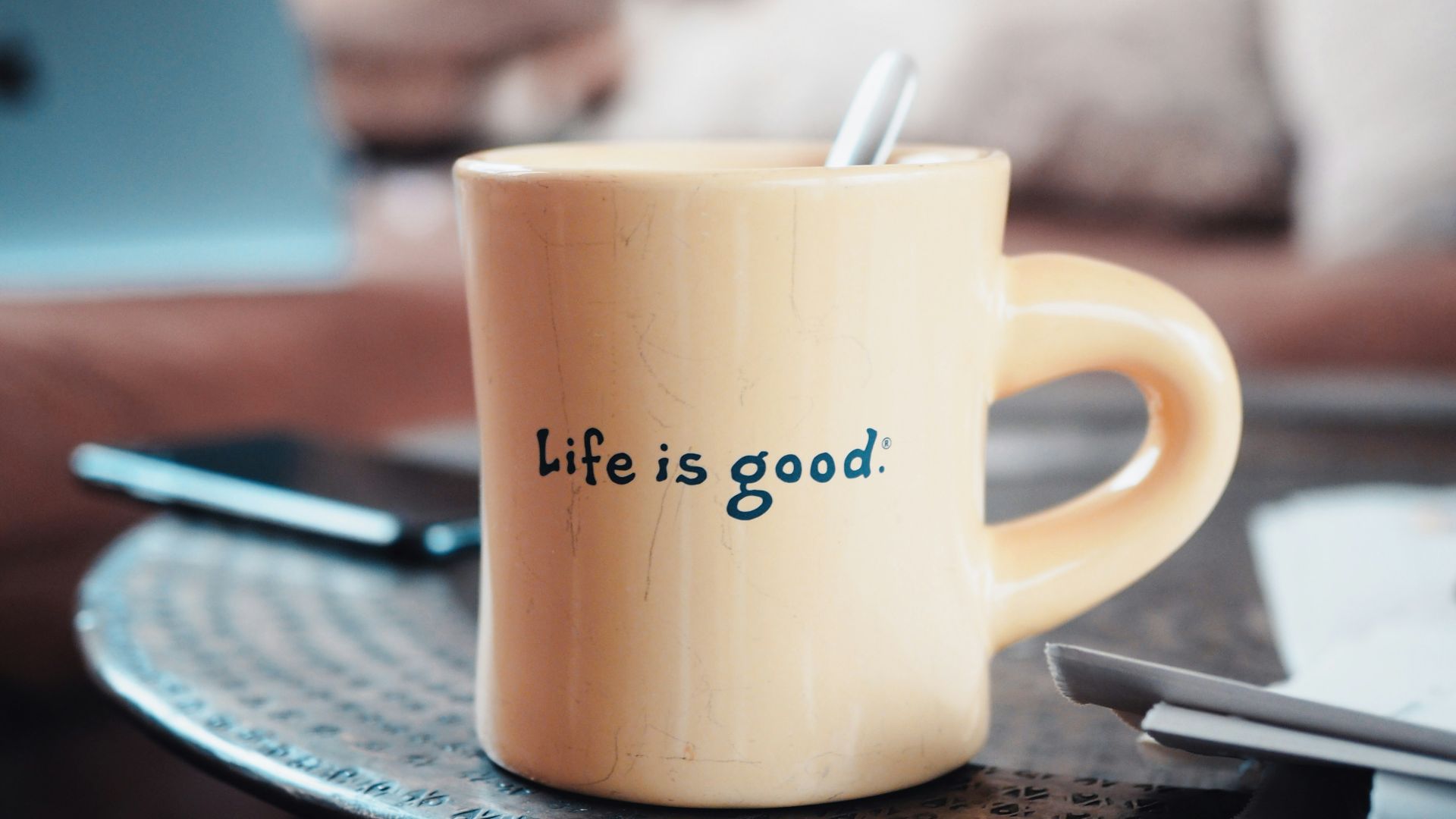 brown ceramic mug on blue and white ceramic plate