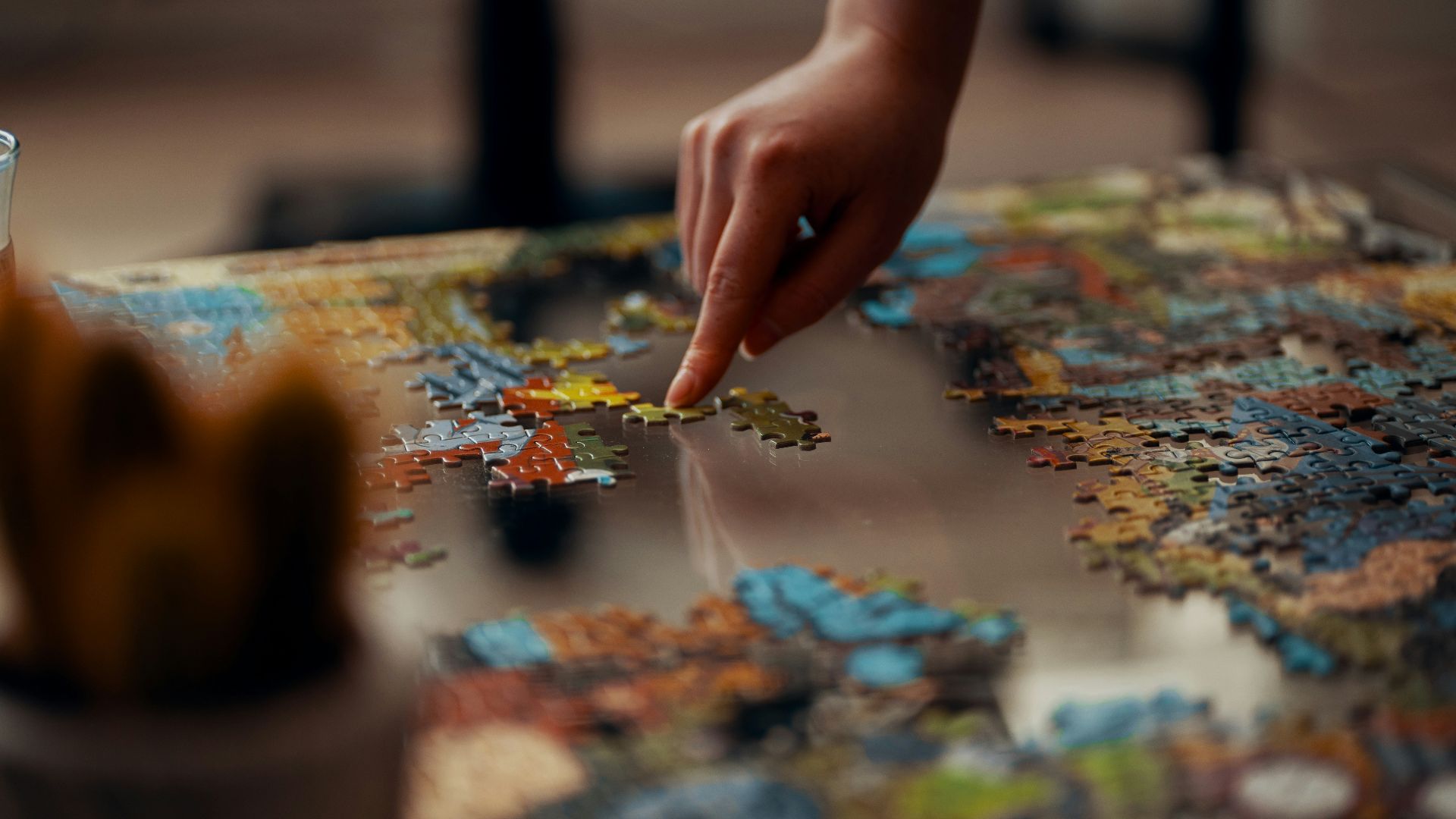 person holding jigsaw puzzle piece