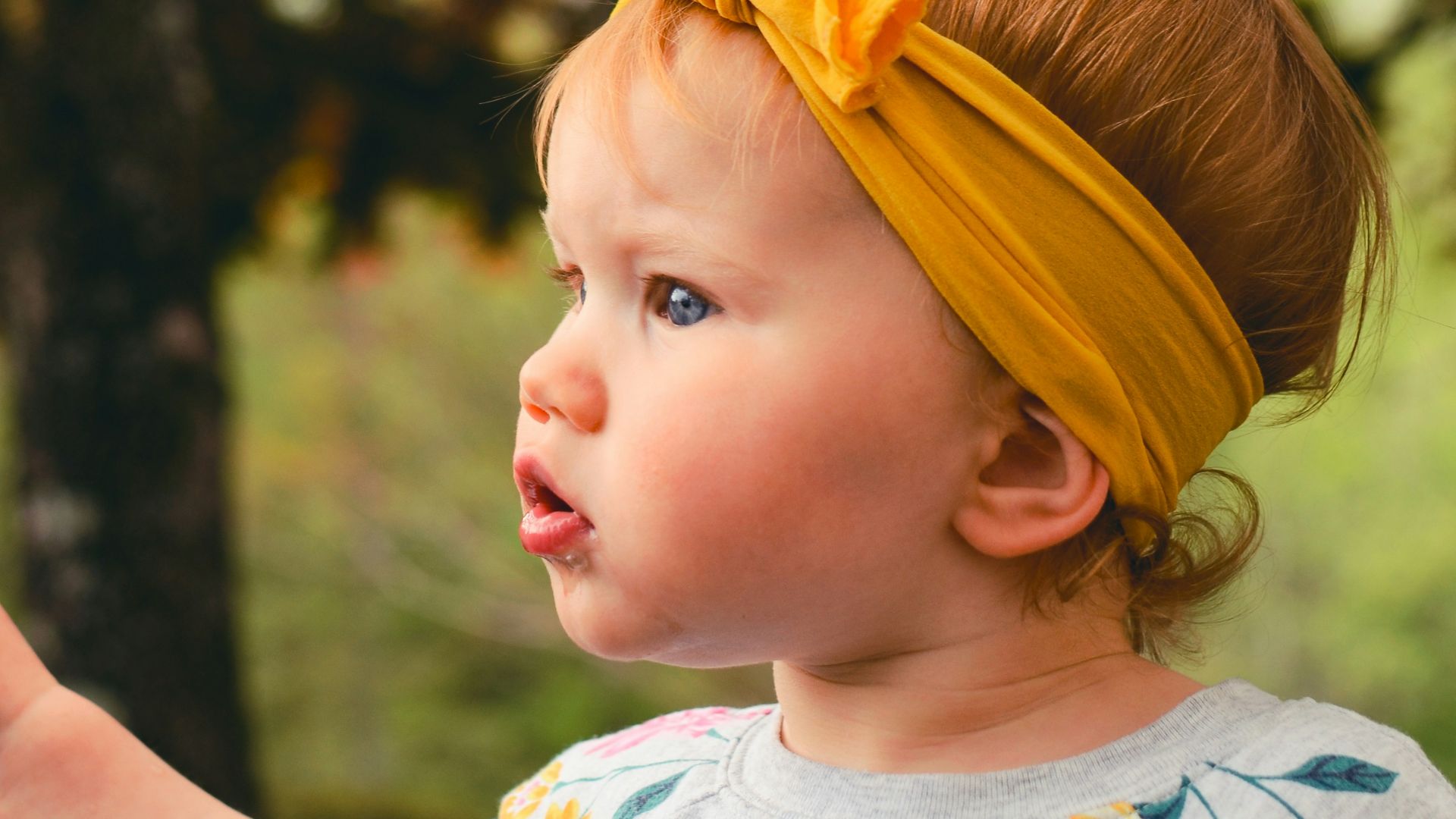 girl wearing gray shirt and yellow headband