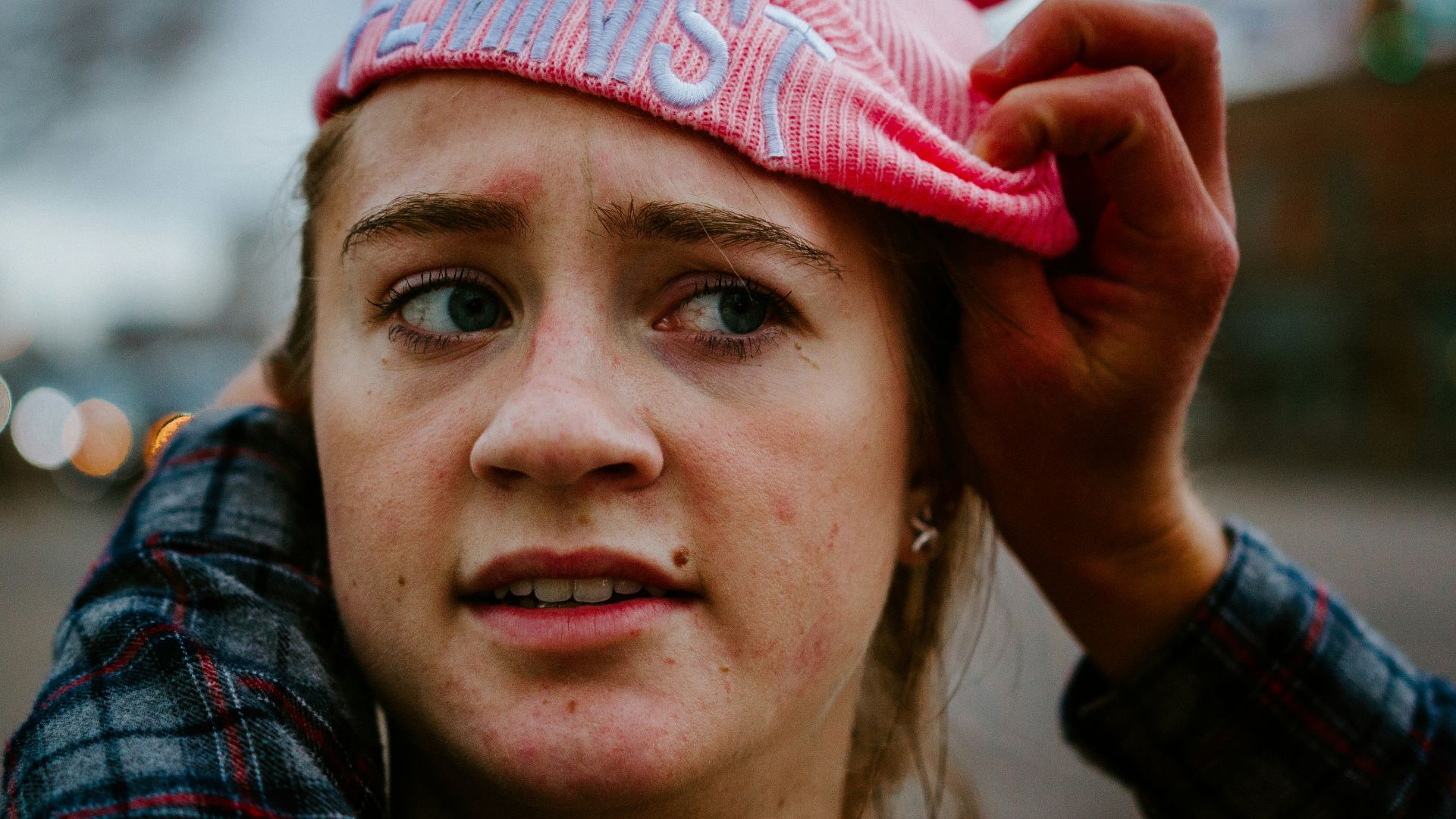 woman in red and white knit cap