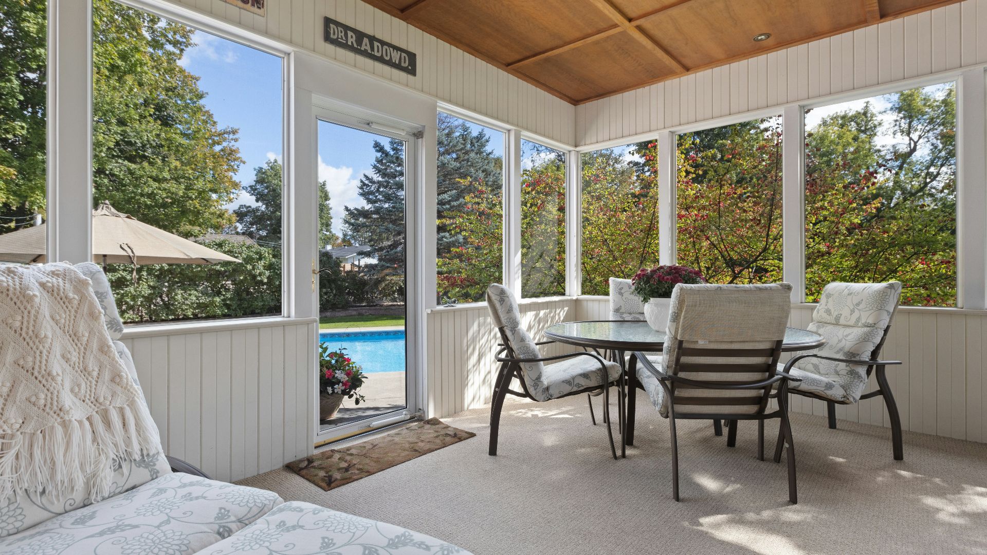 a covered patio with a table and chairs