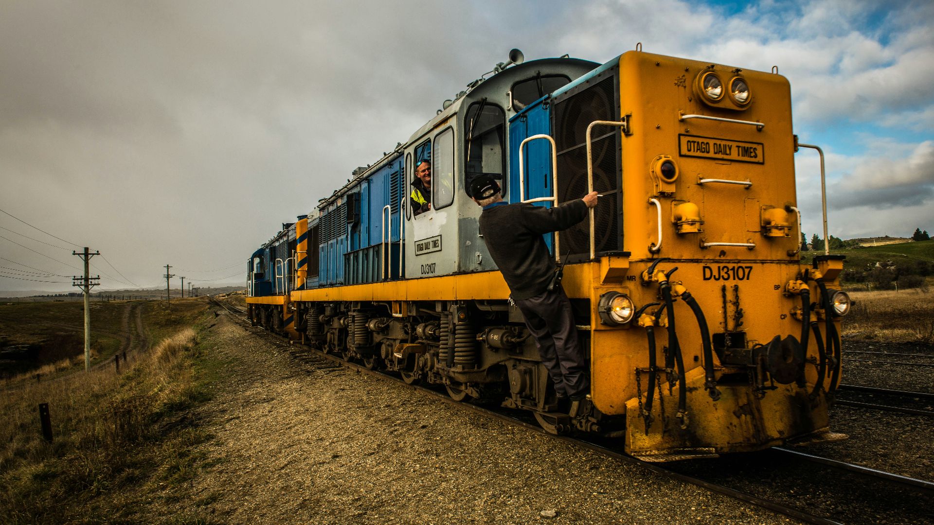 a man standing on the side of a train