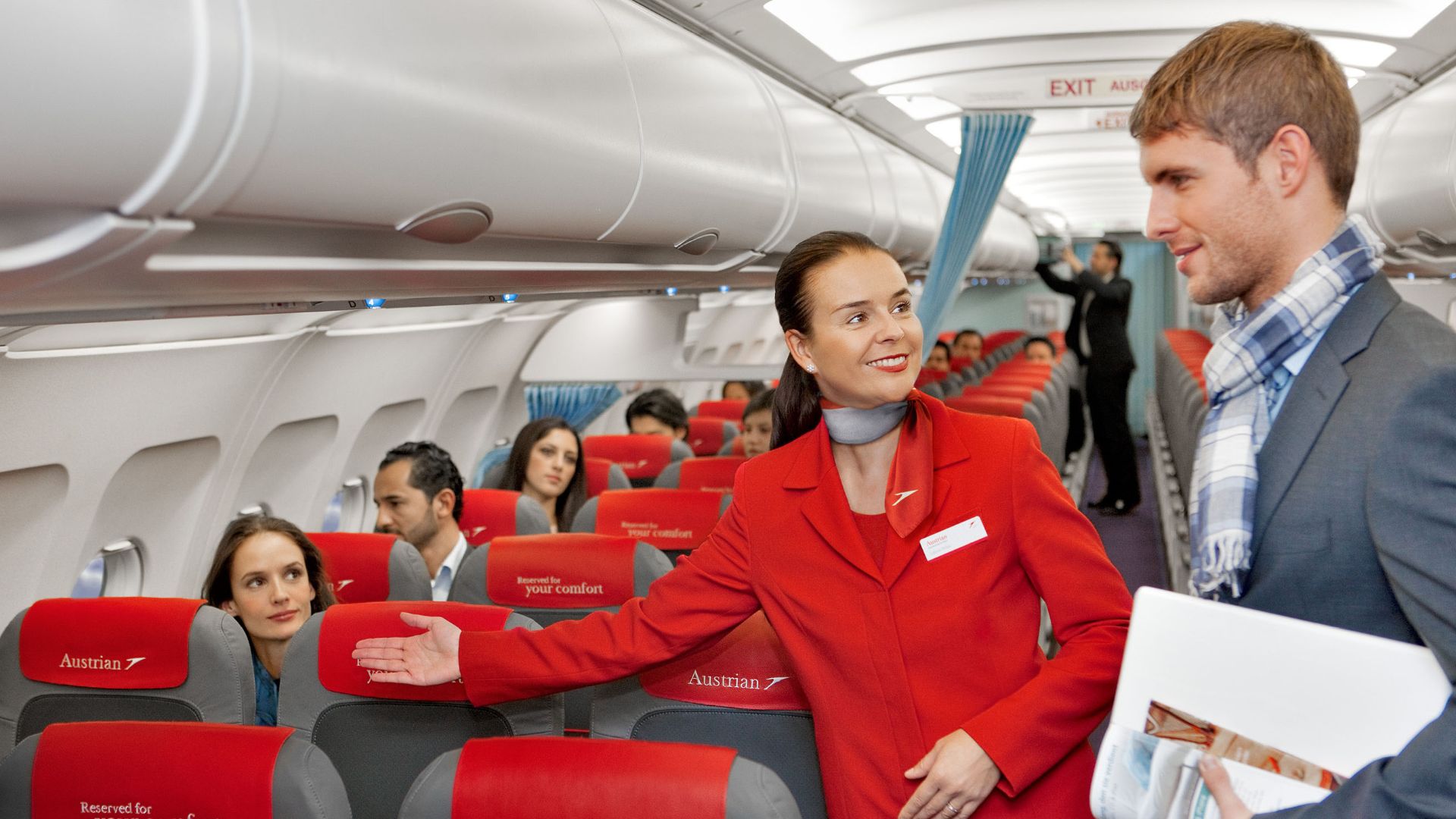 File:Austrian Airlines flight attendant and passenger.jpg