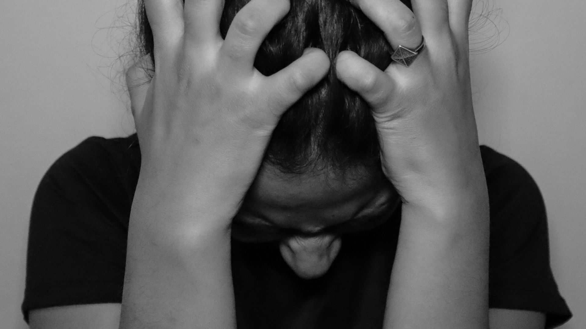 a woman covering her face with her hands