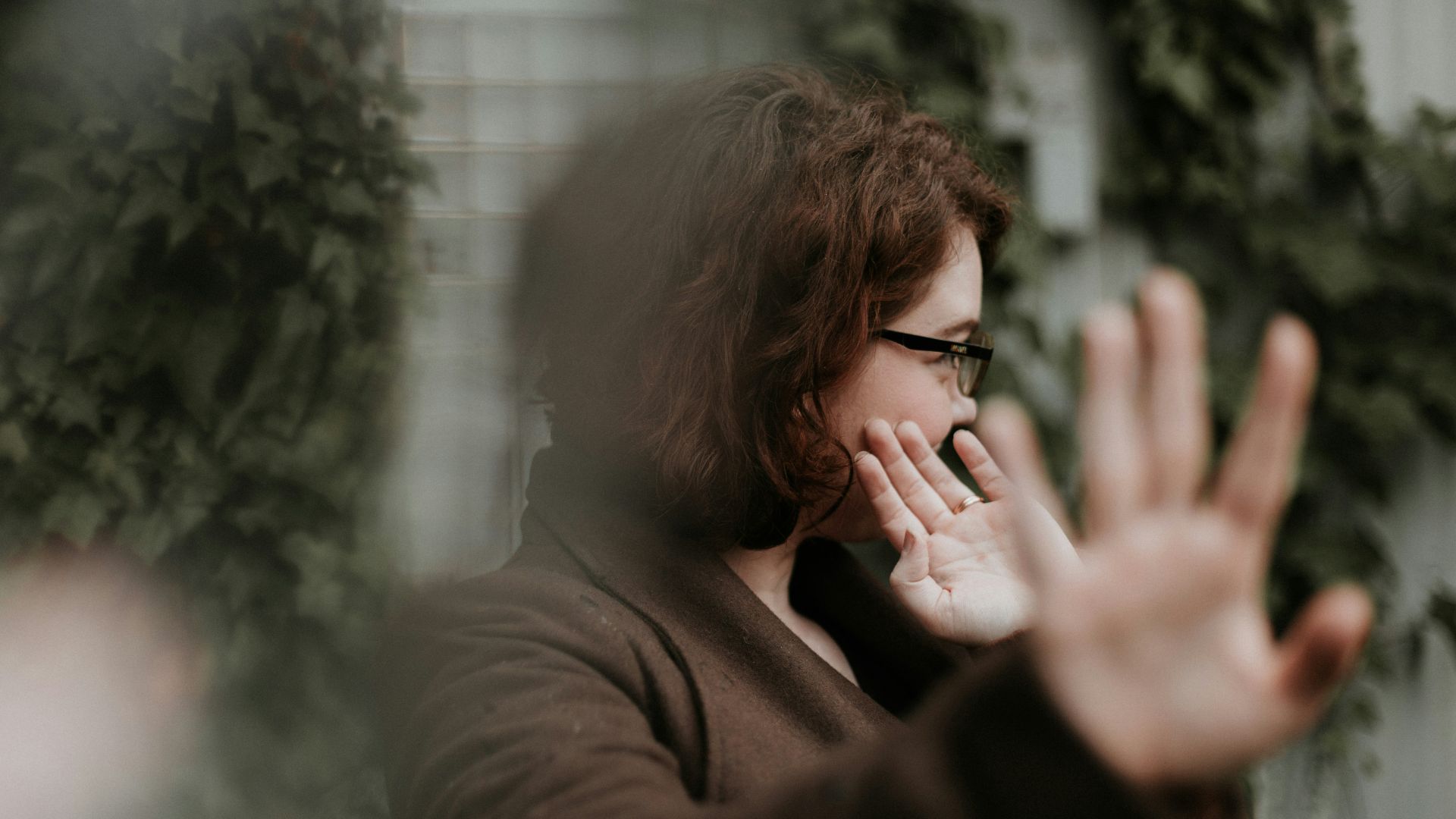 man in brown sweater wearing black framed eyeglasses