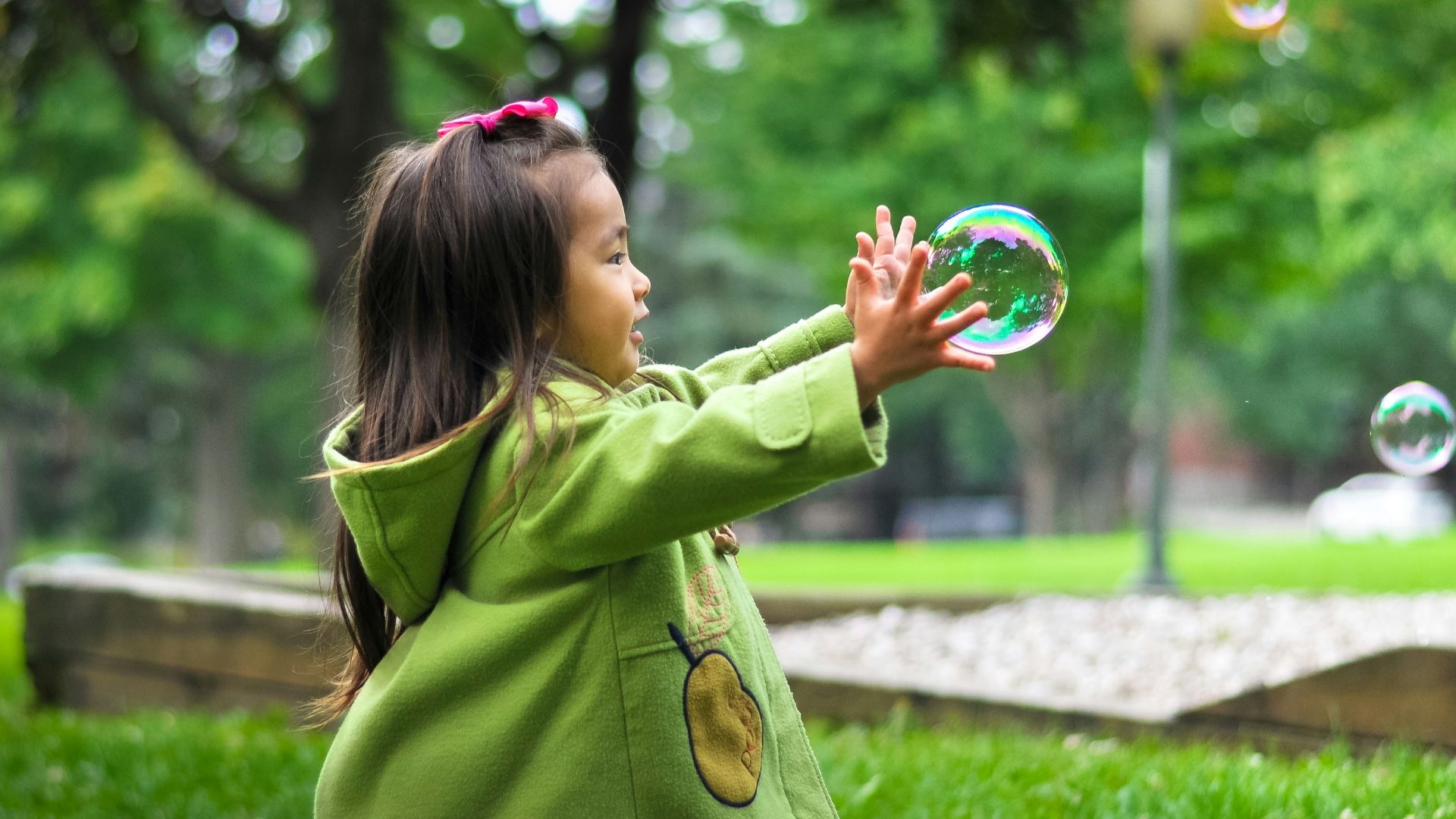 selective photo of a girl holding bubbles