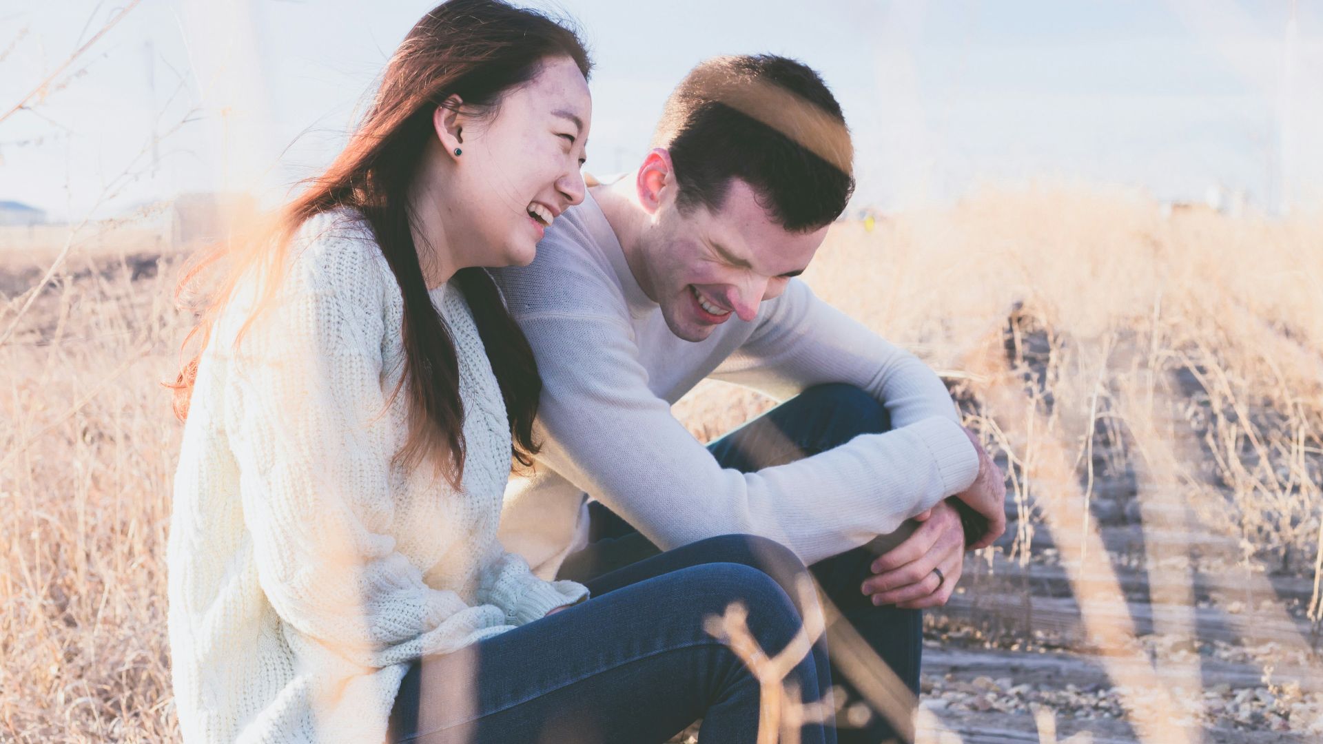 photo of man and woman laughing during daytime