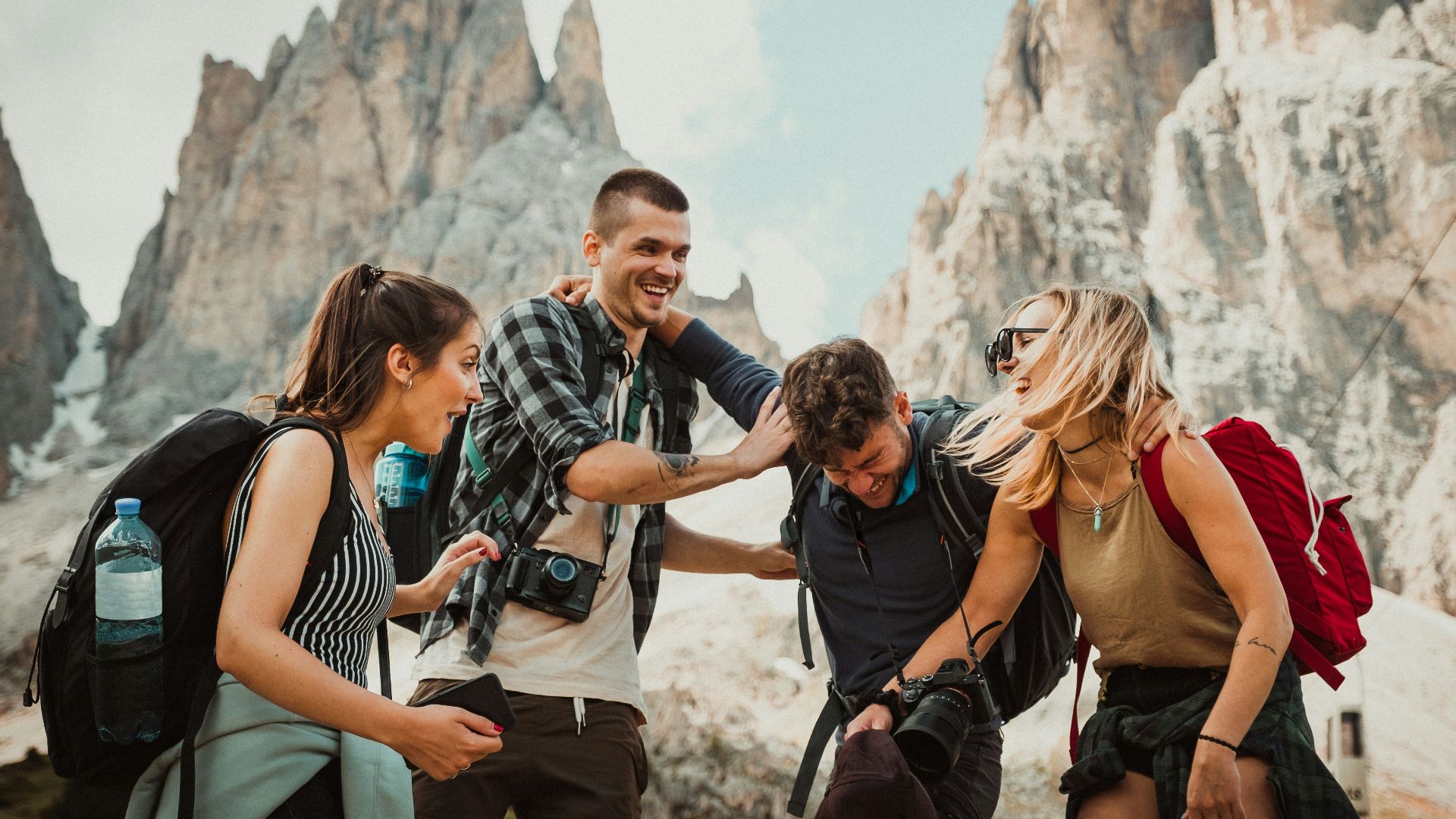 low-angle photography of two men playing beside two women