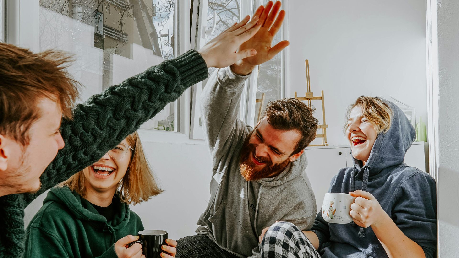 woman in black and white checkered long sleeve shirt sitting beside man in green crew neck