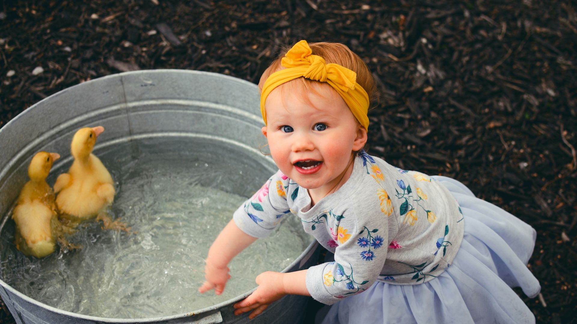 shallow focus photo of girl playing water