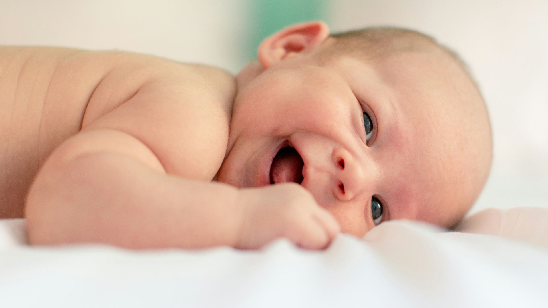 baby lying on fabric cloth