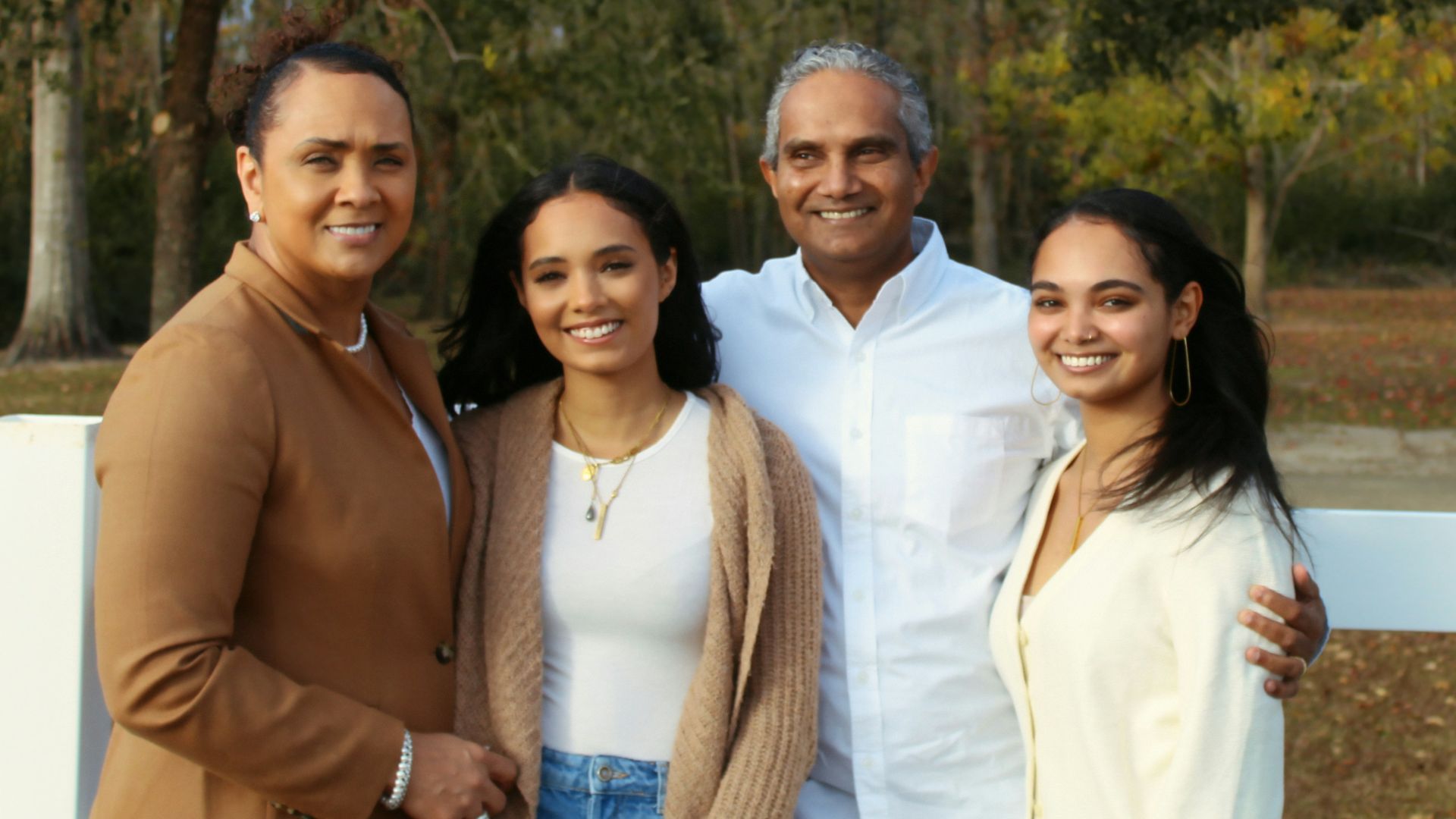 3 women standing near green trees during daytime