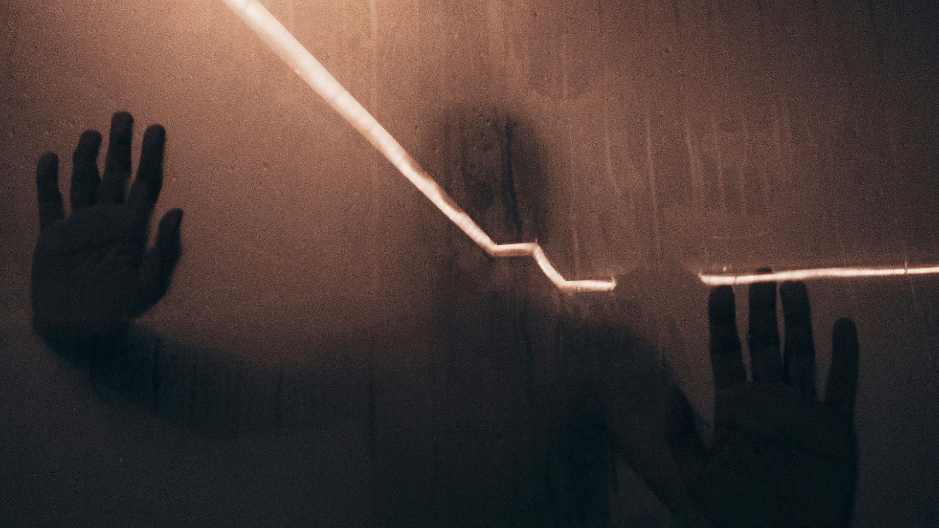 persons hand on white wall