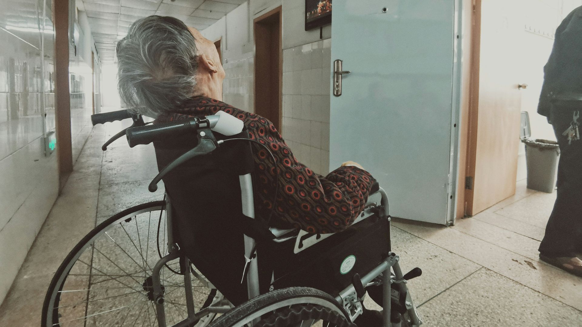 woman in black and white long sleeve shirt sitting on black wheelchair