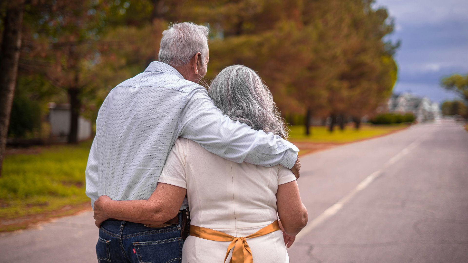 couple kissing on the road during daytime