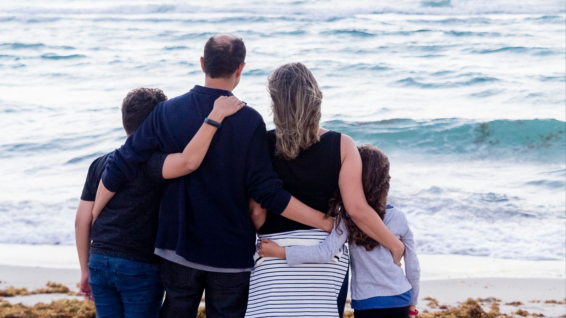 a family of four on a beach
