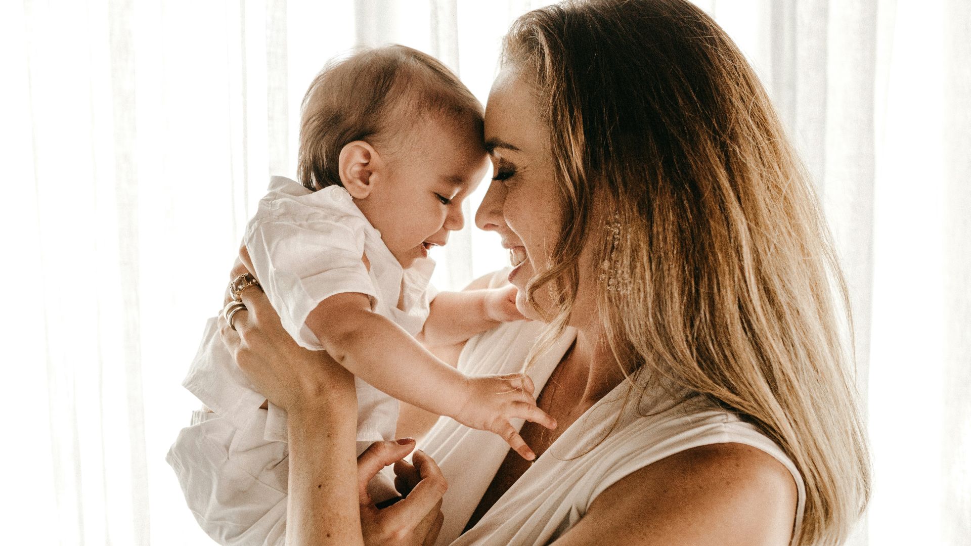 smiling woman carrying baby