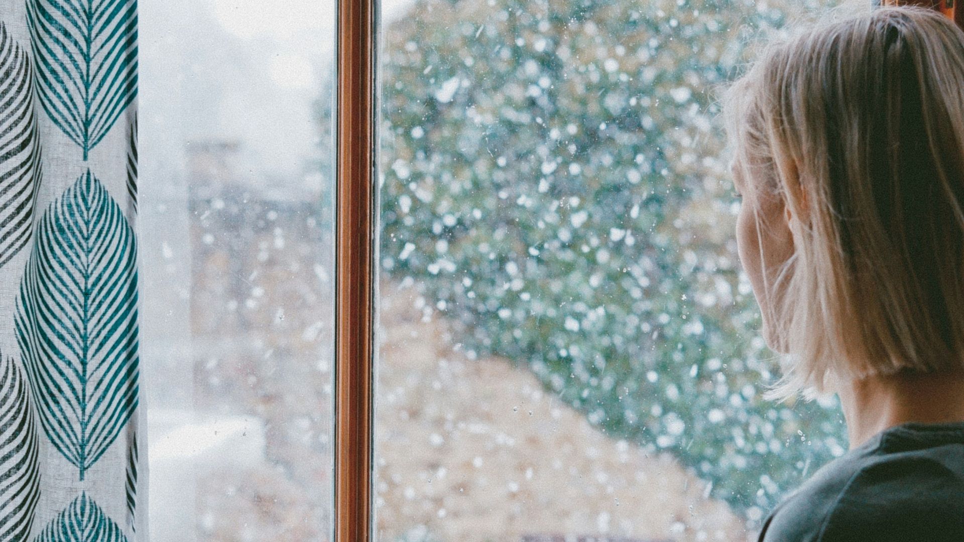 woman standing in front of clear glass window