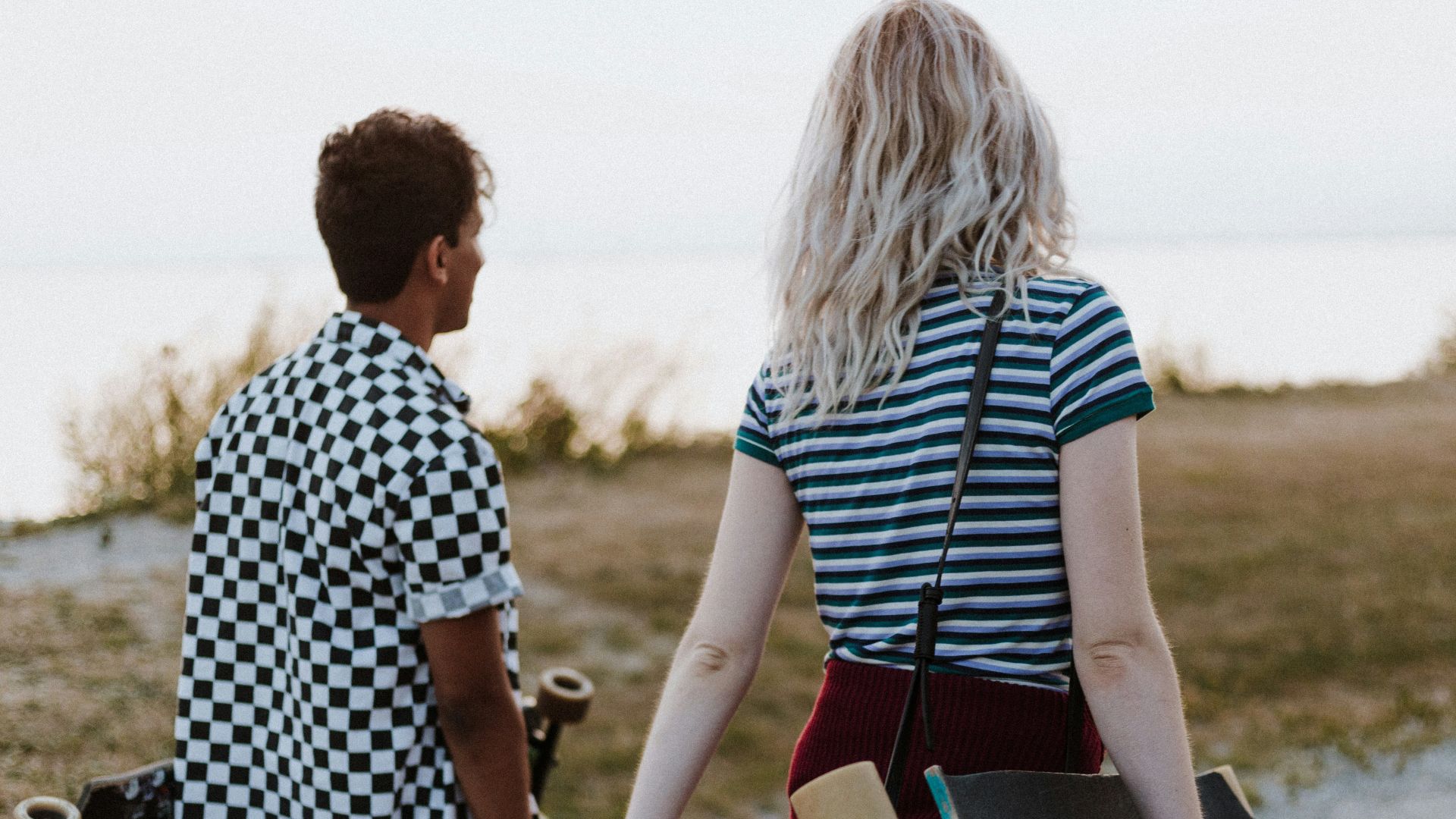 man and woman in white-and-black tops walking on pathway during daytime