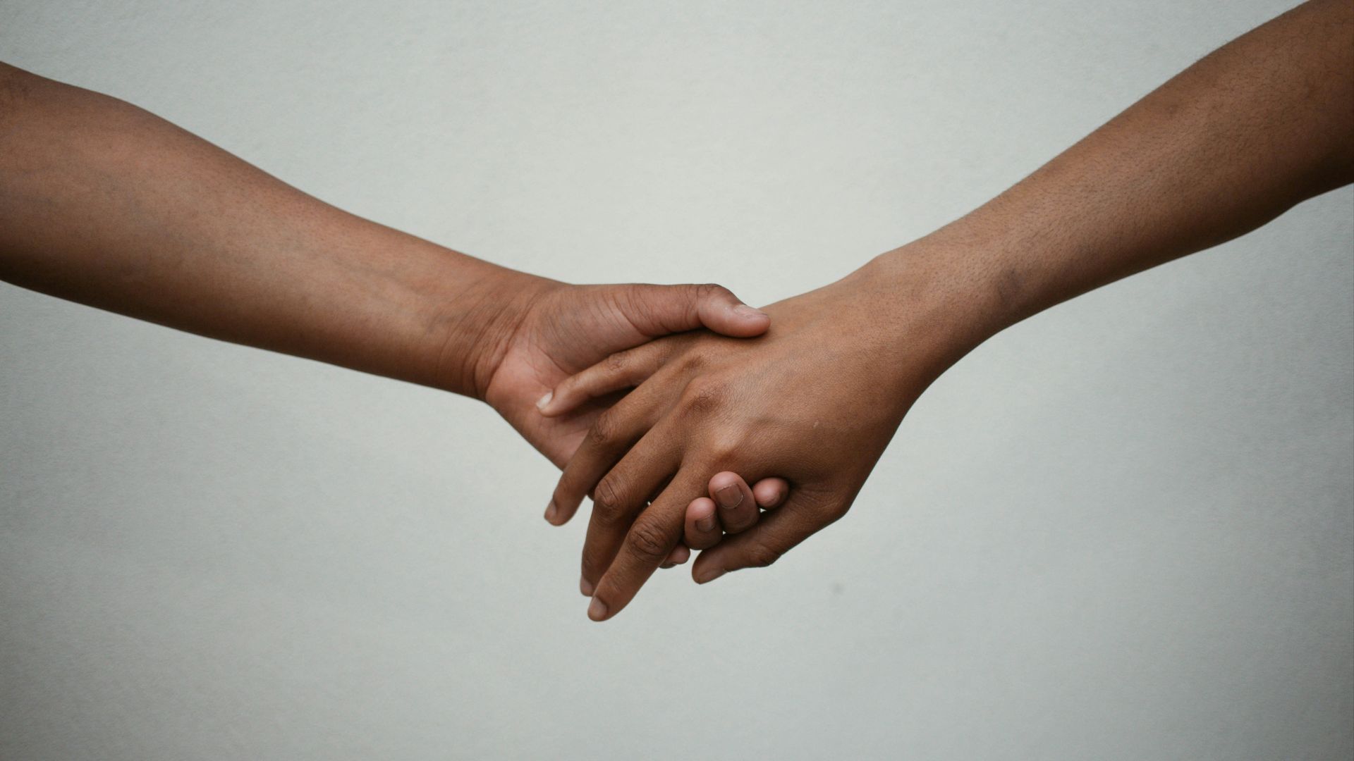 persons hand on white surface