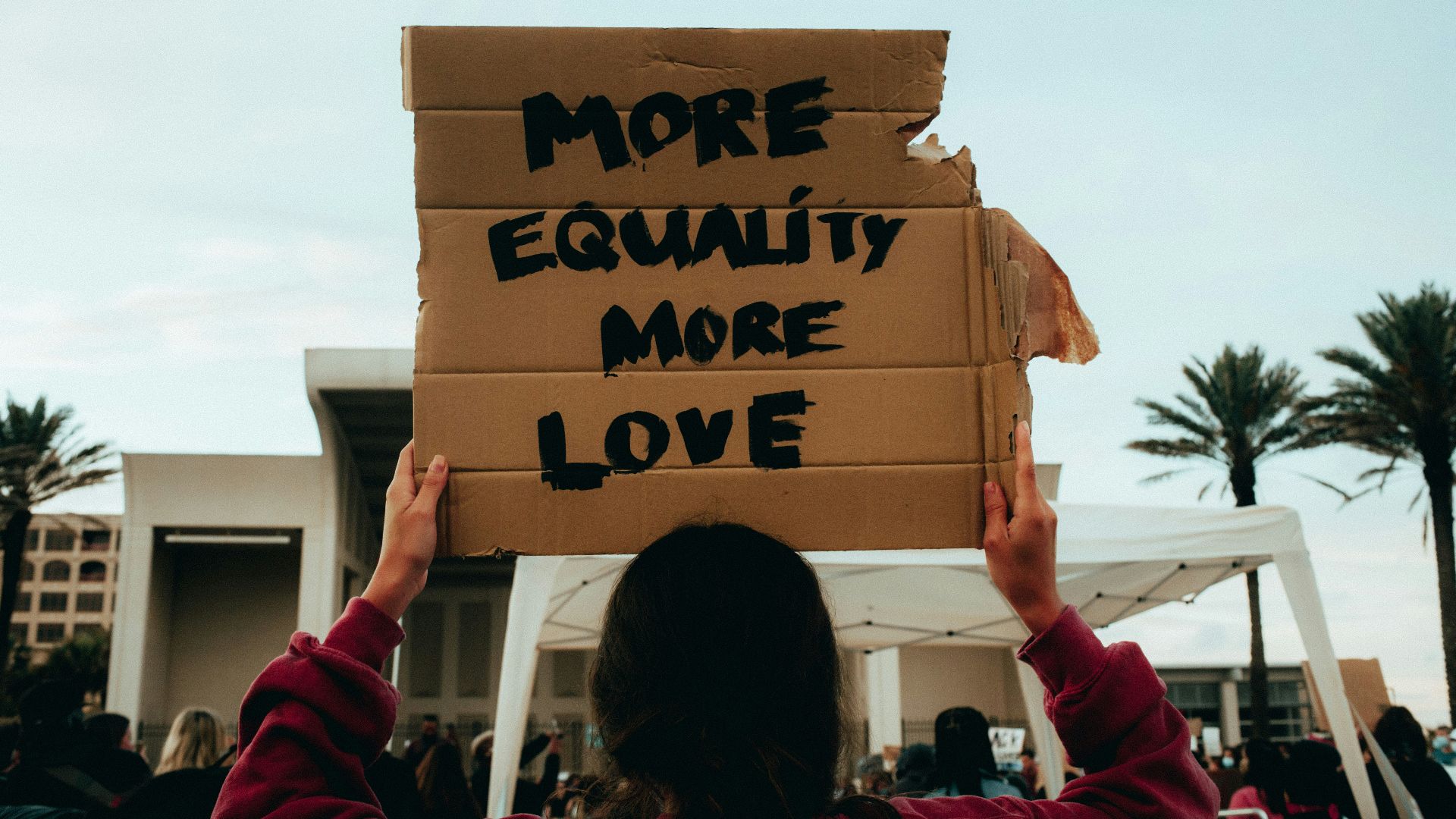 person holding brown cardboard box