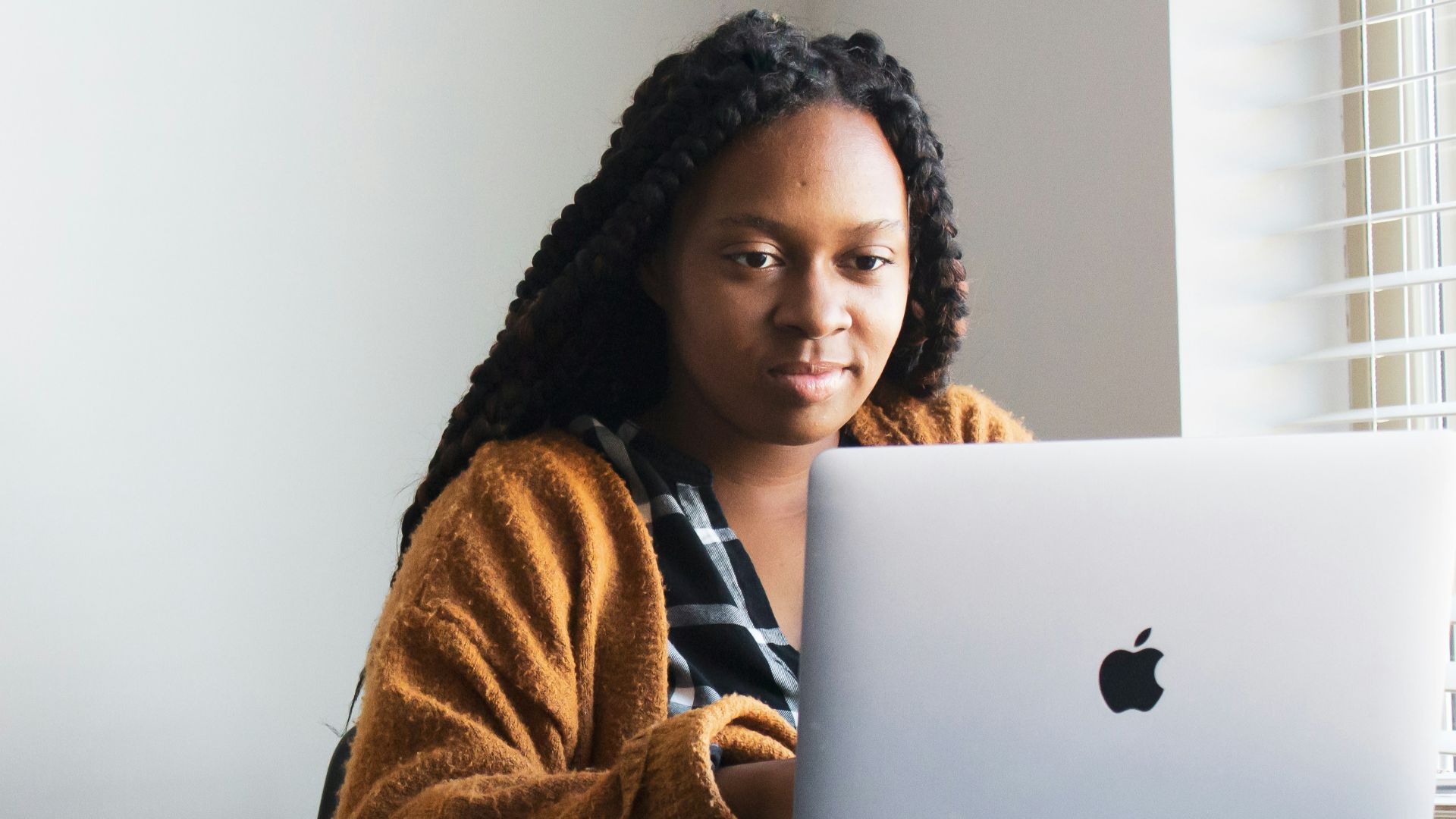 woman in brown and white fur coat sitting on chair