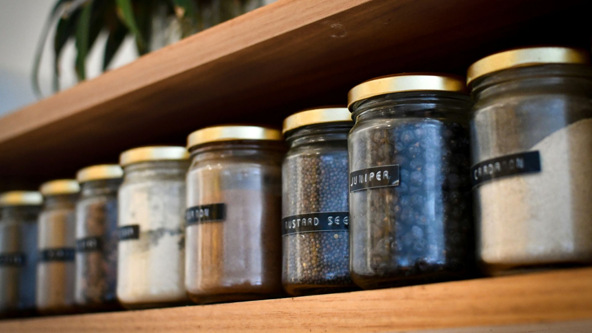 a shelf filled with lots of different types of spices
